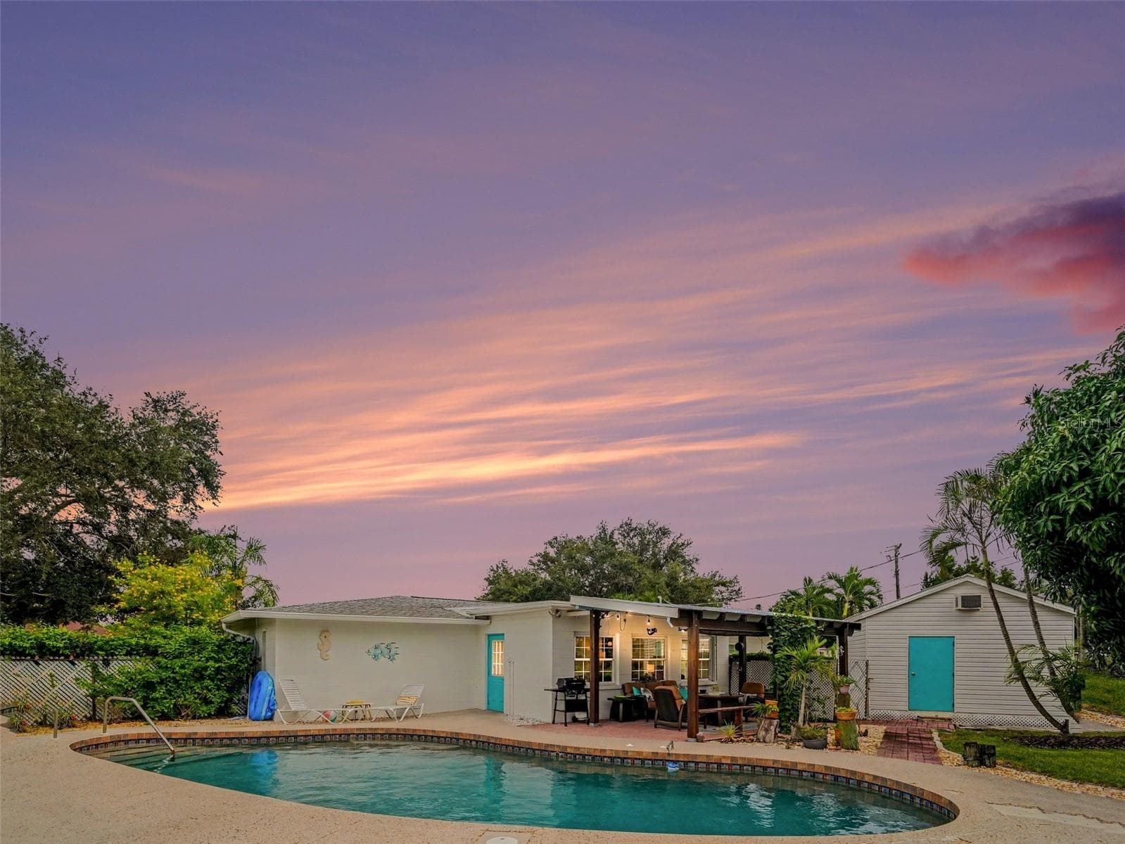 40 FT FREEFORM POOL, COVERED PATIO, WORKSHOP, ADDITIONAL SHED NOT PICTURED.  STUNNING SUNSETS FROM THE PATIO OR WALK DOWN THE STREET TO THE WATER - 1110 DE NARVAEZ AVE, BRADENTON