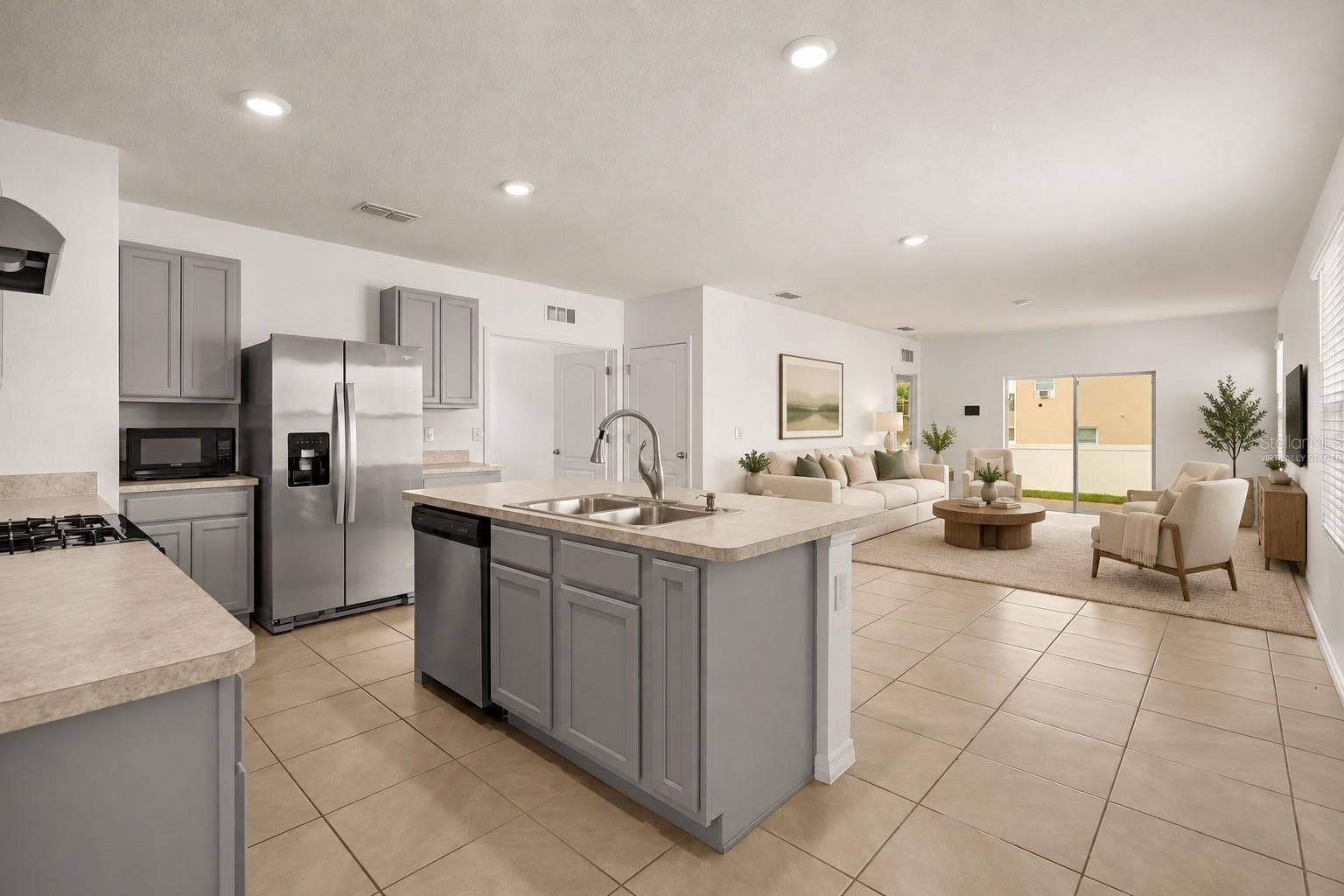 Virtually staged main living area showcasing a comfortable seating arrangement and the spacious open layout. - 3658 CASPIAN ST, LEESBURG