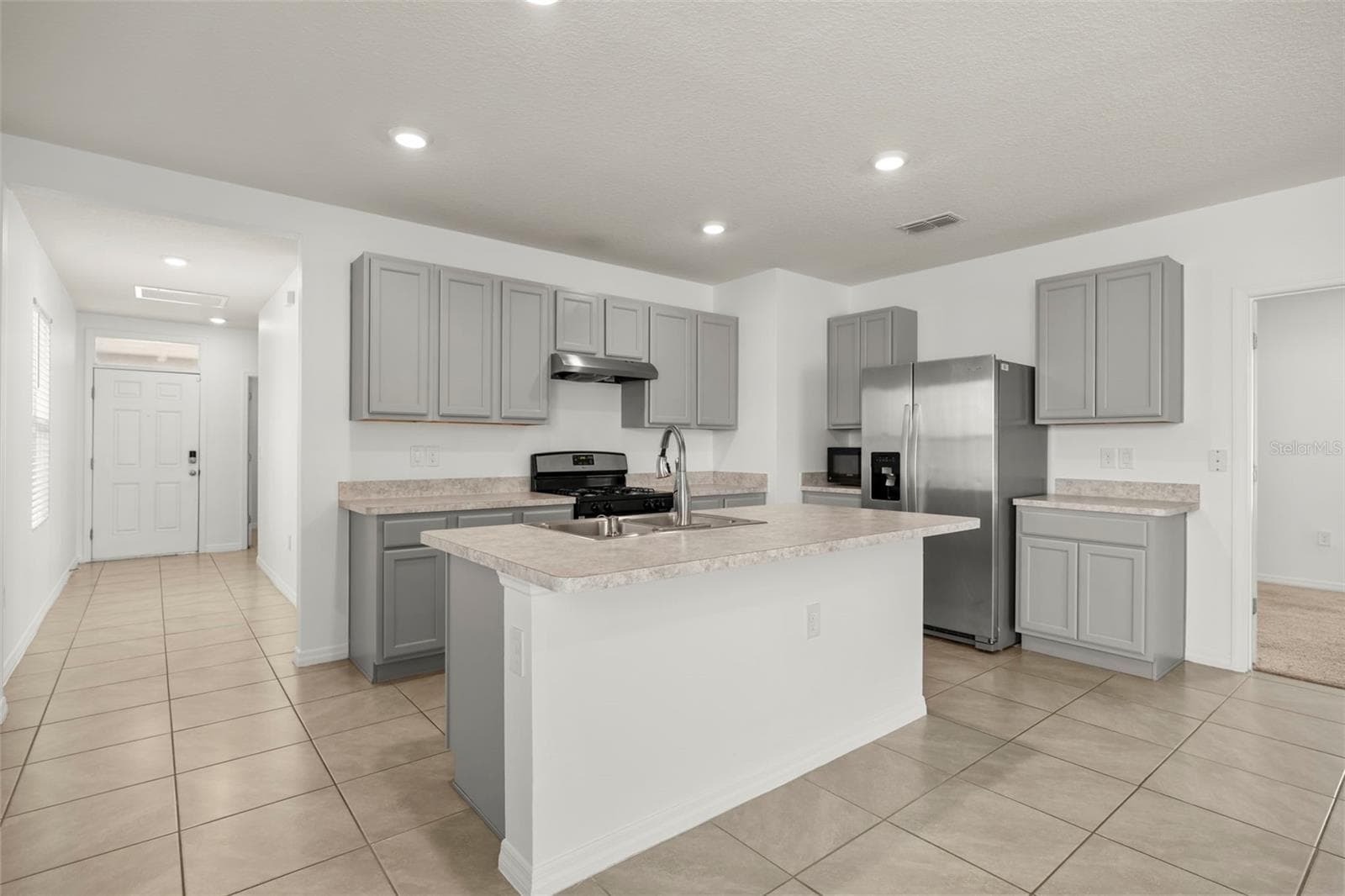 Large center island provides additional prep space and a natural gathering point. - 3658 CASPIAN ST, LEESBURG