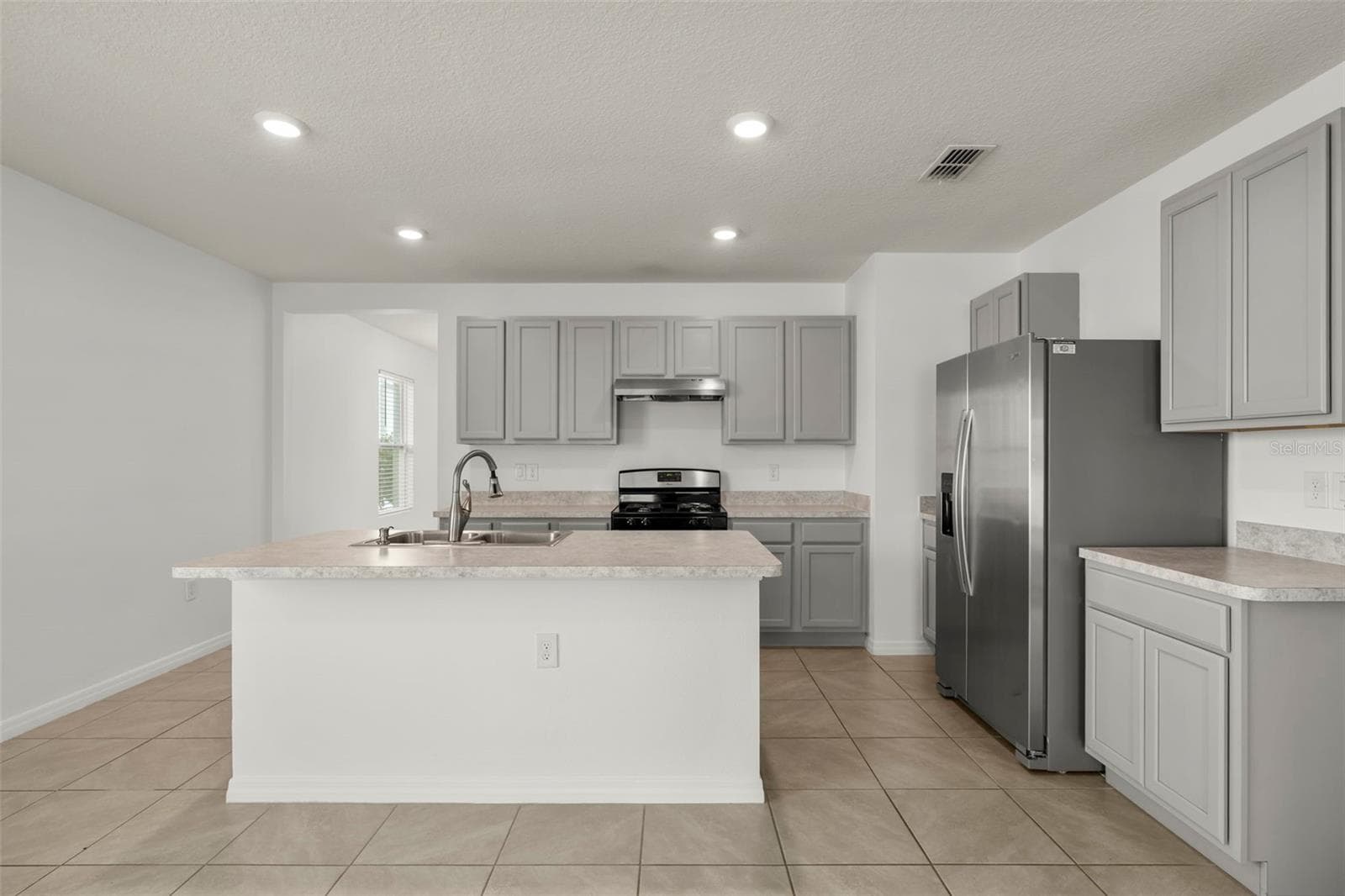 Bright kitchen with stainless steel appliances, abundant cabinetry, and an open layout. - 3658 CASPIAN ST, LEESBURG