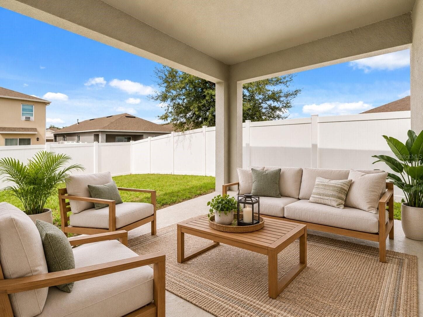 Spacious covered patio overlooking the fenced backyard, virtually staged to showcase the potential for a comfortable outdoor living and entertaining area. - 3658 CASPIAN ST, LEESBURG