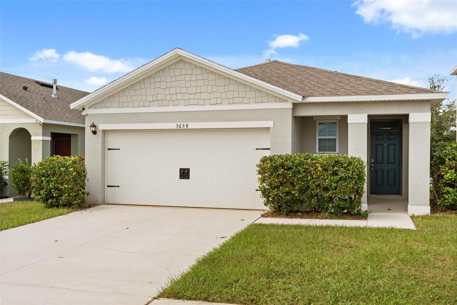 Attractive front elevation with a spacious driveway, 2-car garage, and well-kept landscaping. - 3658 CASPIAN ST, LEESBURG