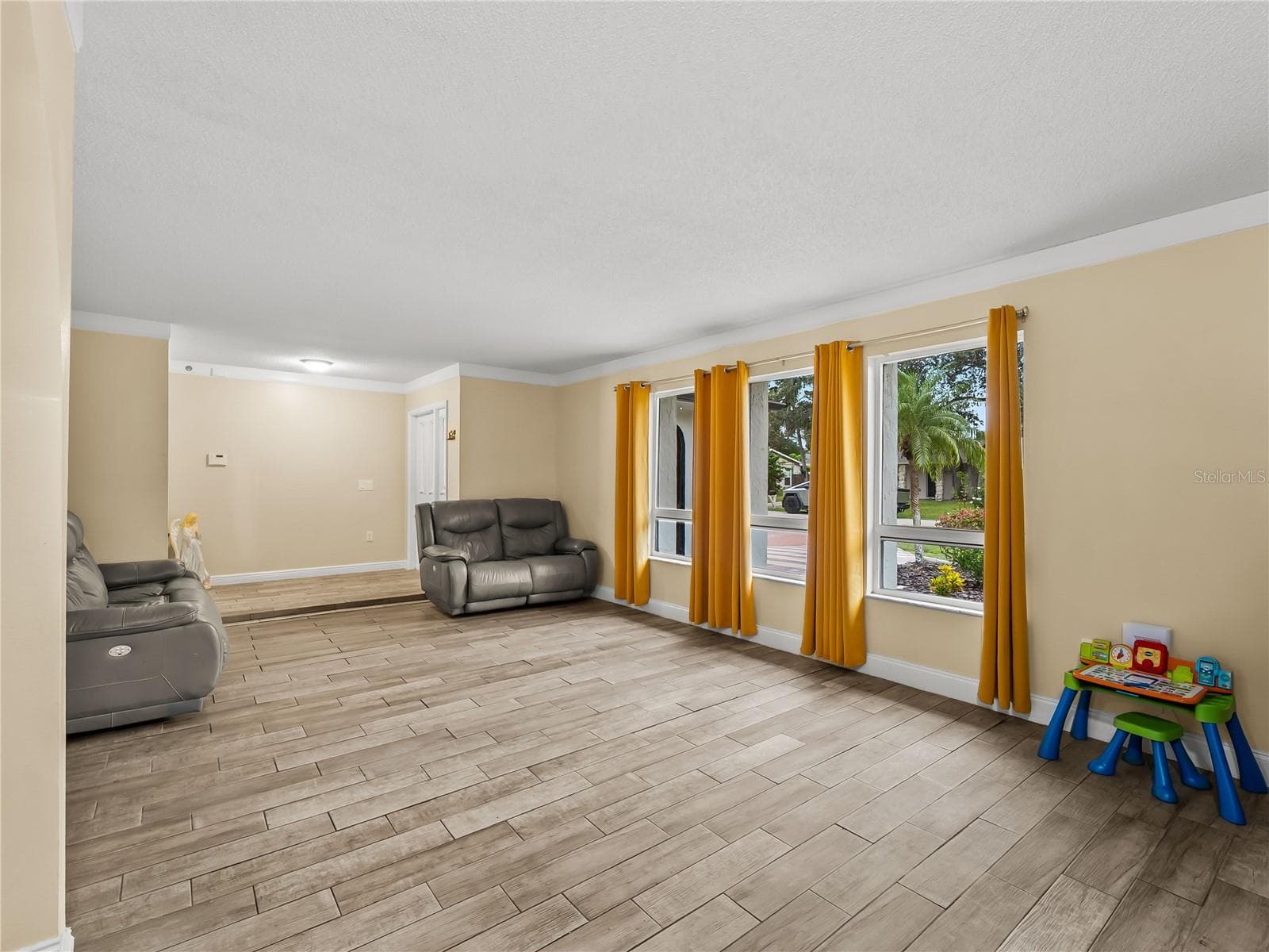 Living room looking back towards the foyer.  Ample natural light. - 20343 RUTHERFORD AVE, PORT CHARLOTTE
