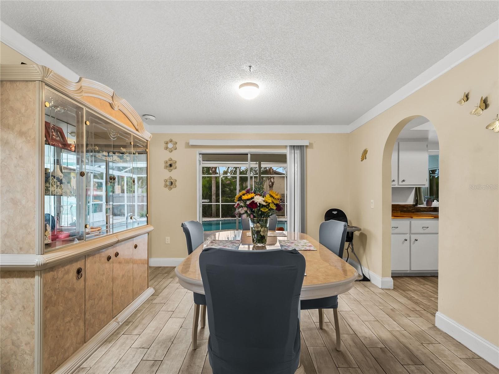 Dining room looking towards the SLD to the pool area.  Kitchen on the right. - 20343 RUTHERFORD AVE, PORT CHARLOTTE