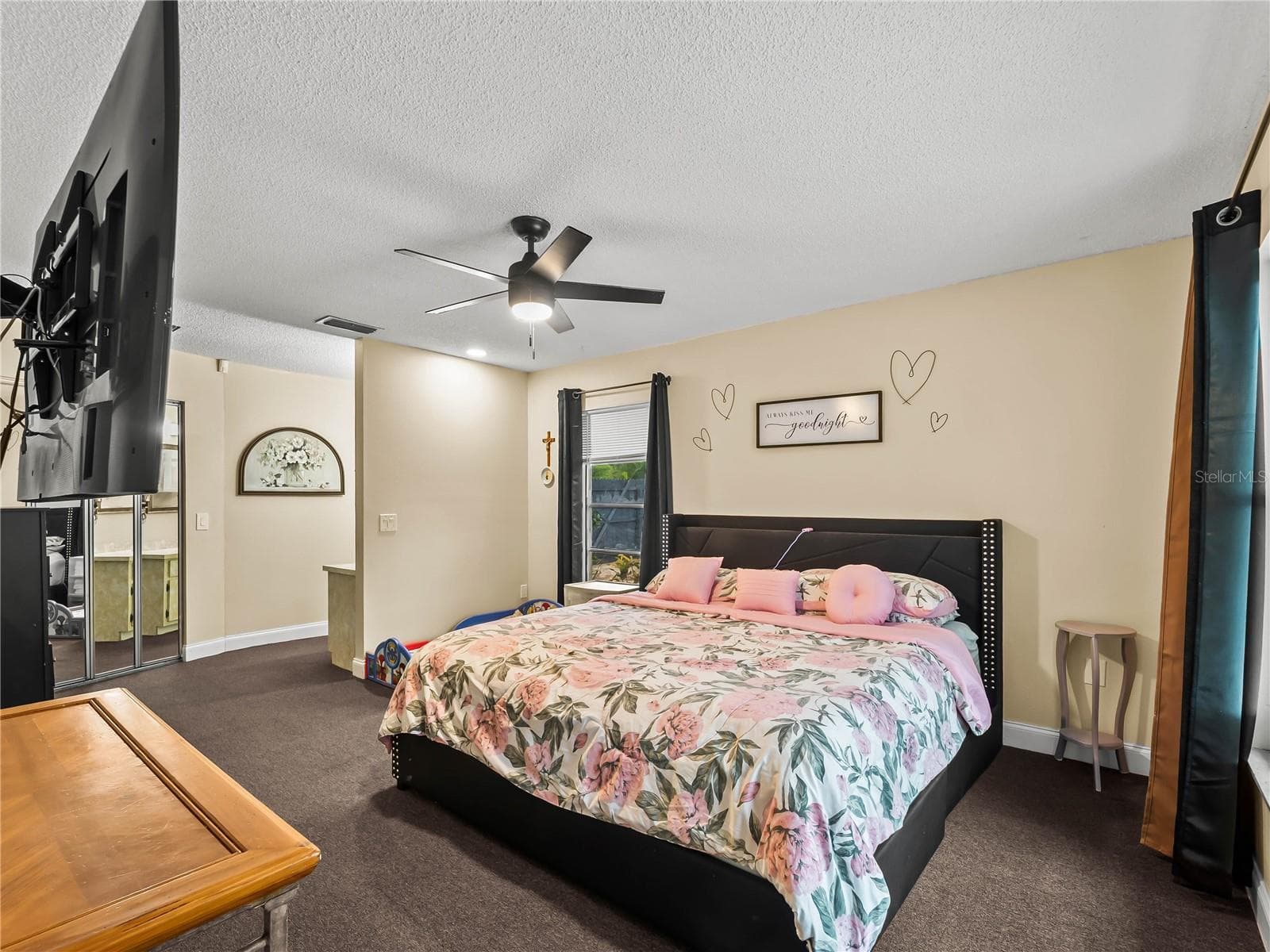 Primary bedroom: walk-in closet behind mirrored doors, vanity to the right of the closet. - 20343 RUTHERFORD AVE, PORT CHARLOTTE