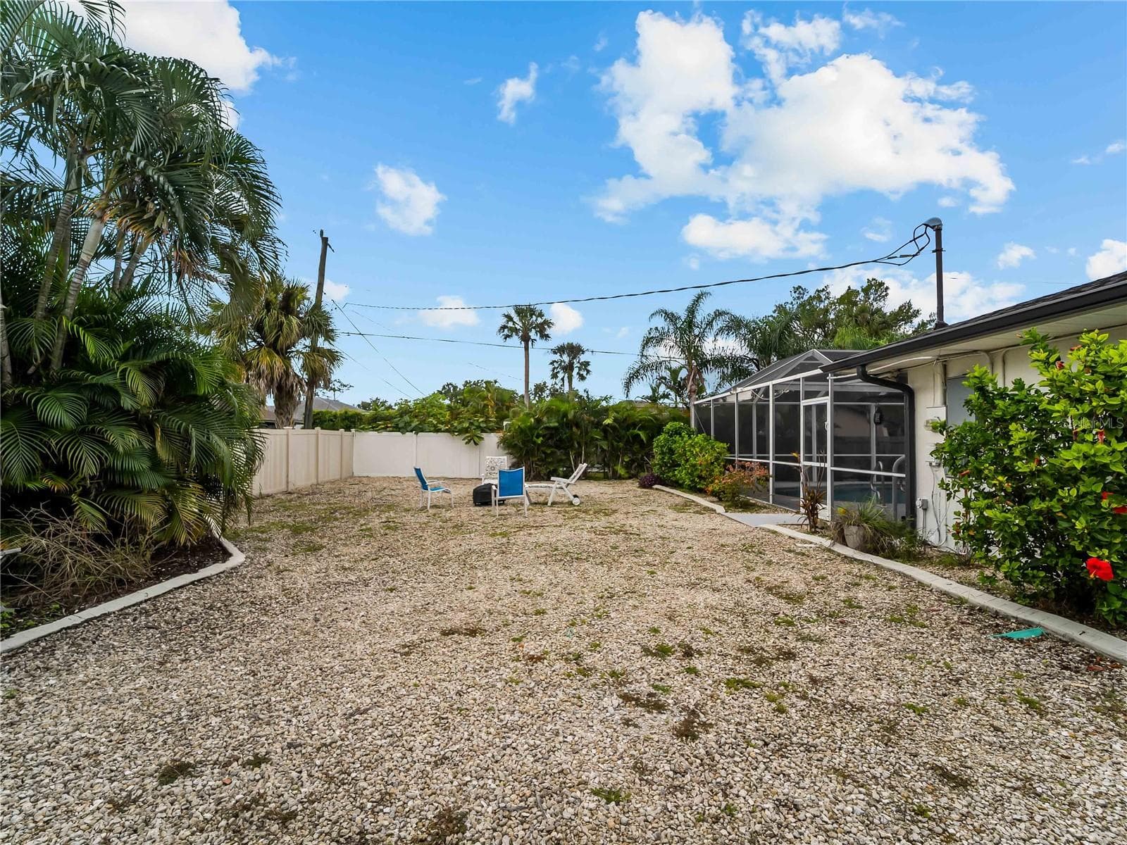 Right side yard.  Note the concrete landscape curbing all around. - 20343 RUTHERFORD AVE, PORT CHARLOTTE
