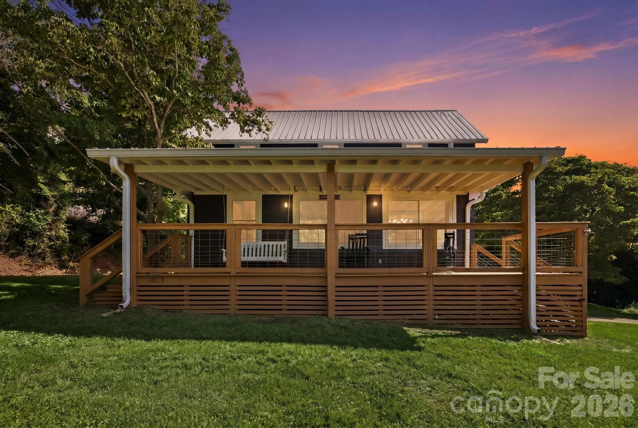 Relax on the expansive and private front porch complete with swing and rockers - 2252 Riceville Road, Asheville