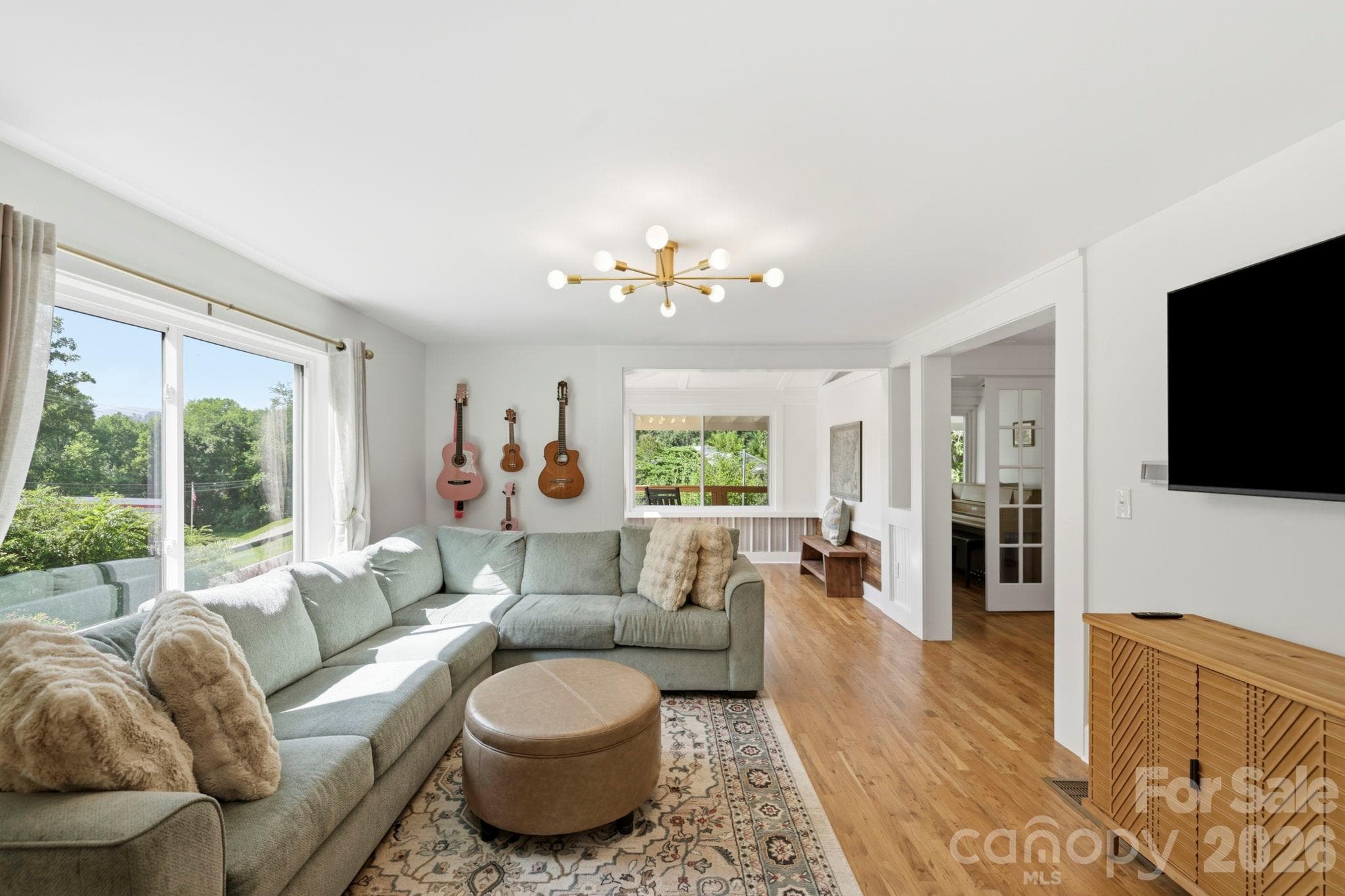 Spacious and bright living room with original hardwood floors - 2252 Riceville Road, Asheville