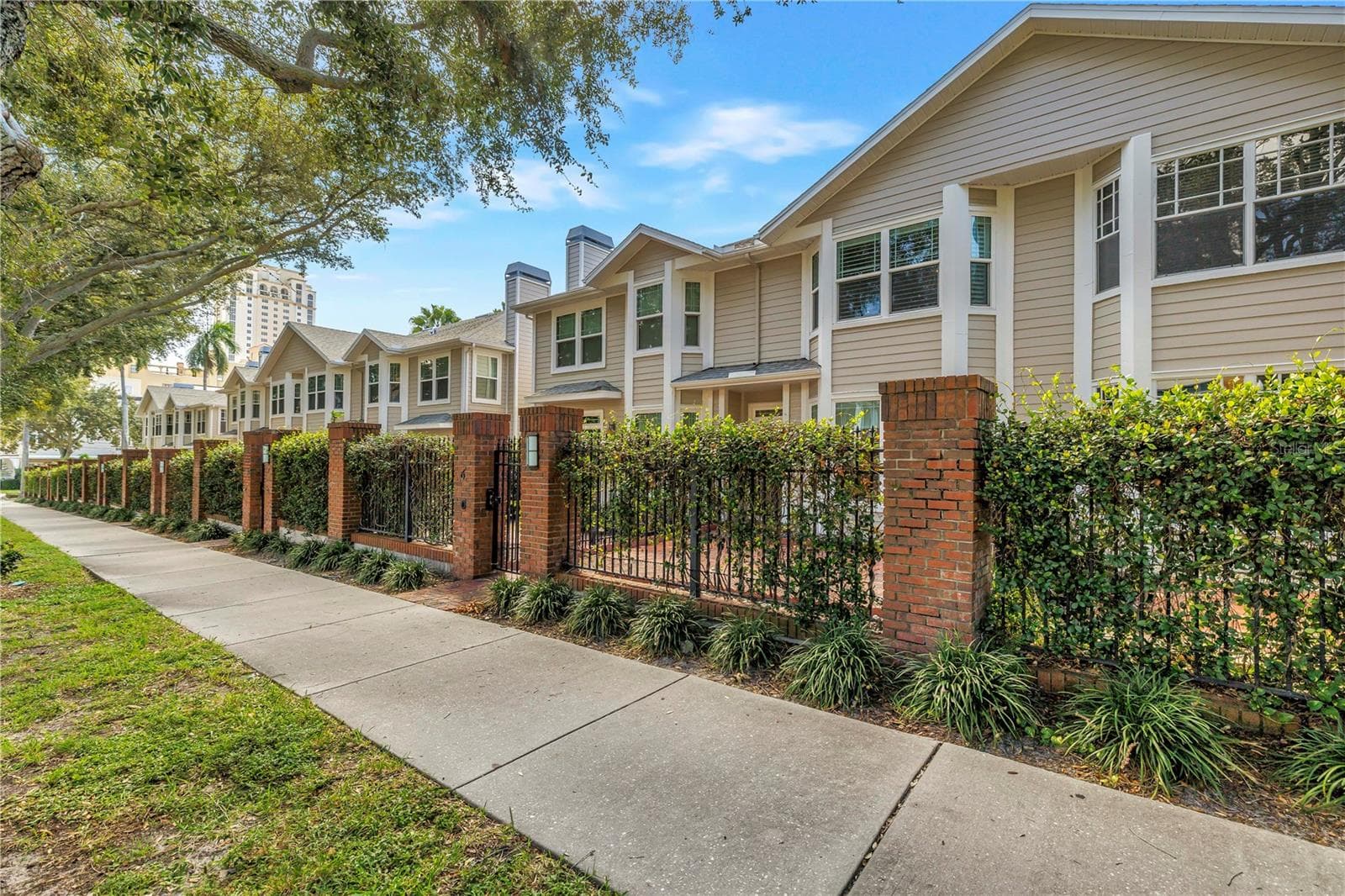 Tree-lined streetscape highlights the distinctive architecture and intimate residential setting of The Huntington. - 350 2ND ST N #6, ST PETERSBURG