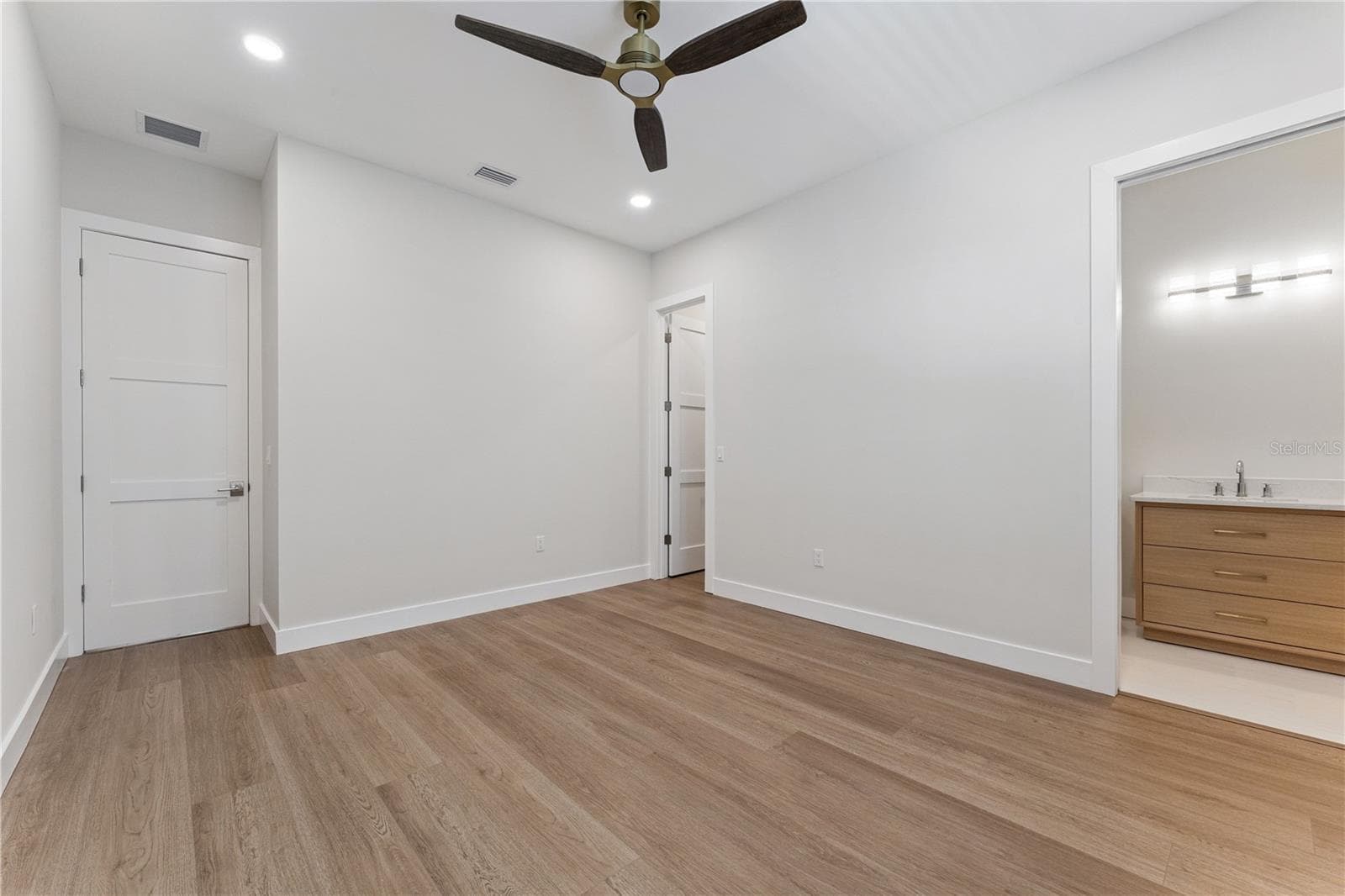 This bedroom includes a shuttered window, ceiling fan, and a view into the built-in closet. - 3456 FAIRWAY LN, ORLANDO