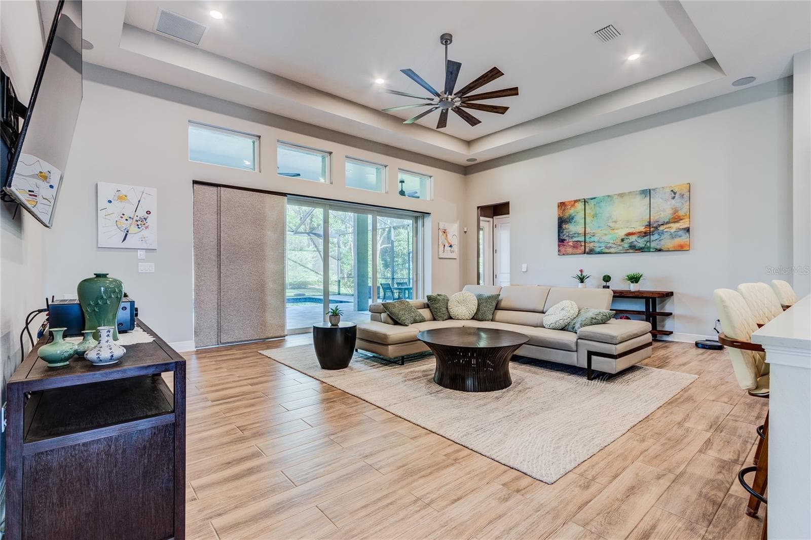 Great Room Tray ceiling with disappearing sliders to pool area - 13303 TRAILING MOSS DR, DADE CITY