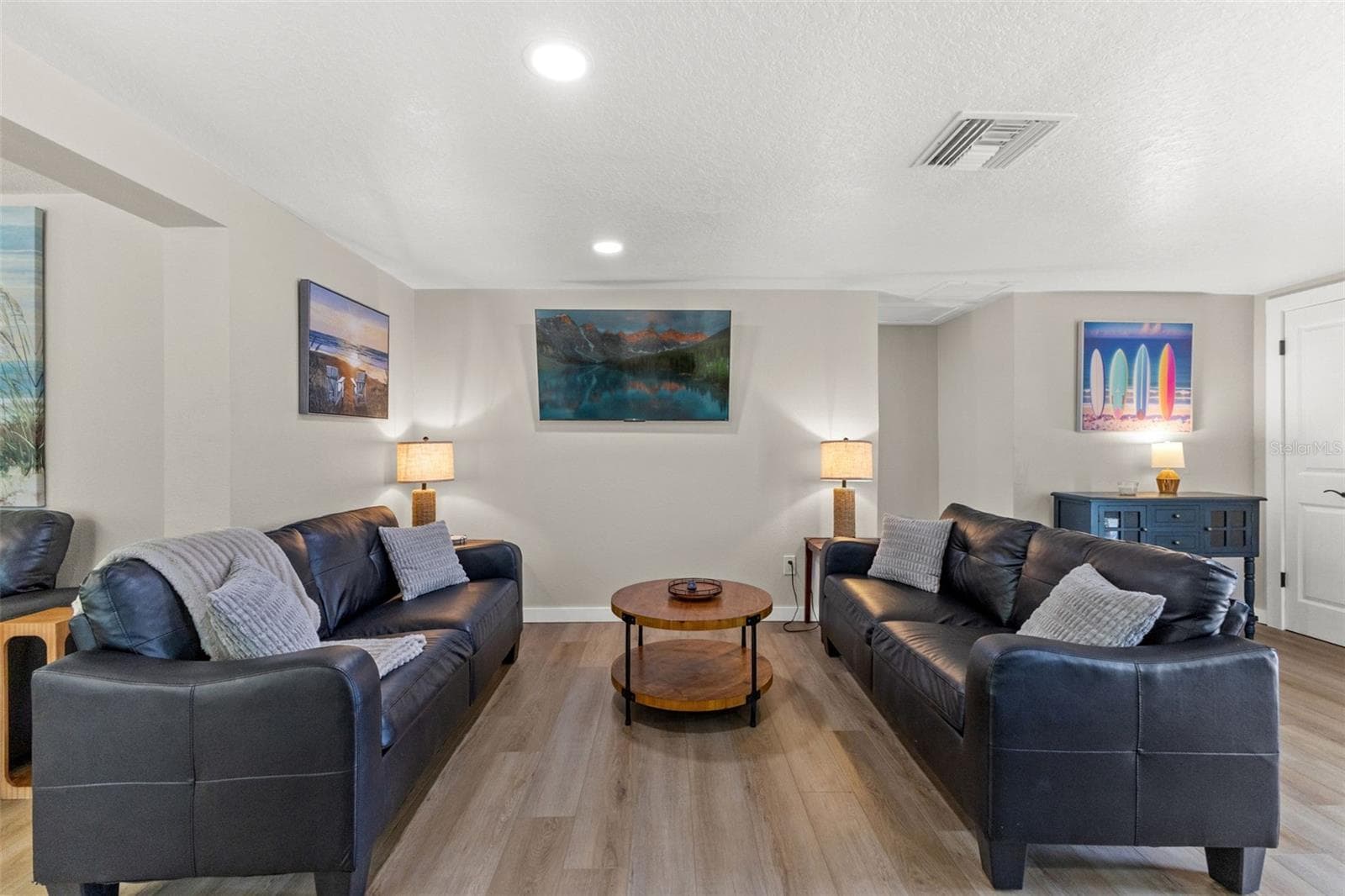 Spacious main living area with luxury vinyl plank flooring and an open layout that connects easily to the kitchen and dining spaces. - 201 SOUTH ST, PALM HARBOR