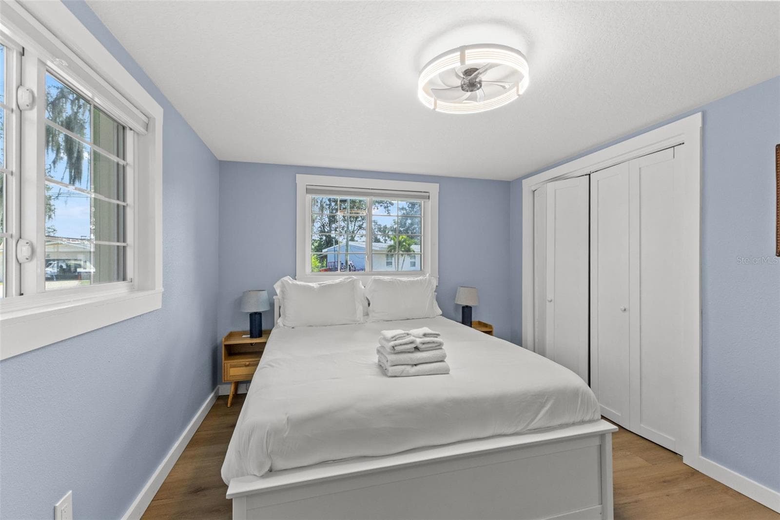 Another view of the bedroom highlights the natural light, closet storage, and no-carpet flooring. - 201 SOUTH ST, PALM HARBOR