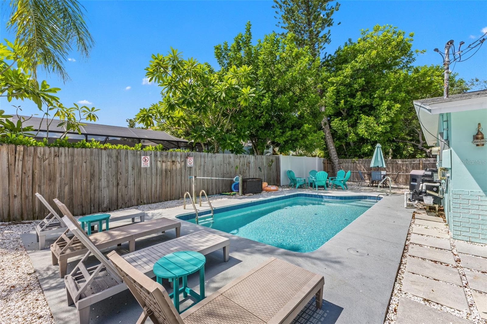 Your own private Florida retreat with a heated pool, lounging space, and a fully fenced yard. - 201 SOUTH ST, PALM HARBOR