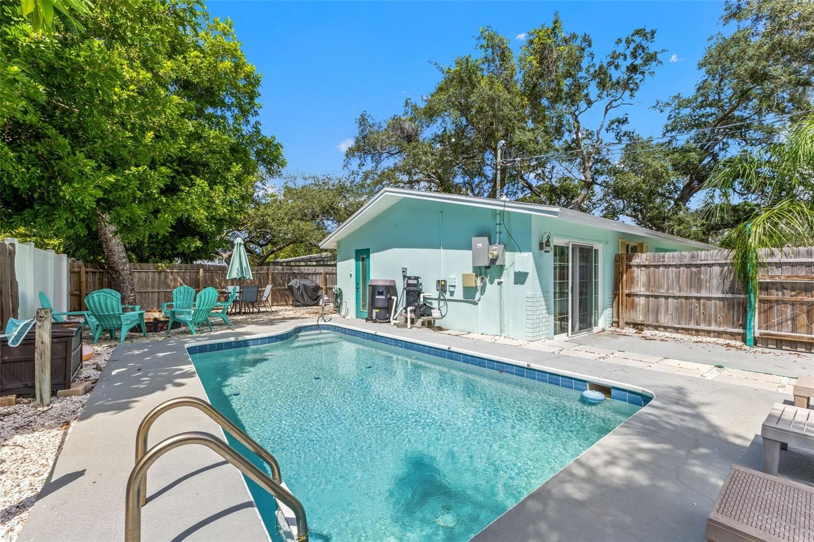Another view of the private pool and fully fenced outdoor space, with direct access to the home. - 201 SOUTH ST, PALM HARBOR
