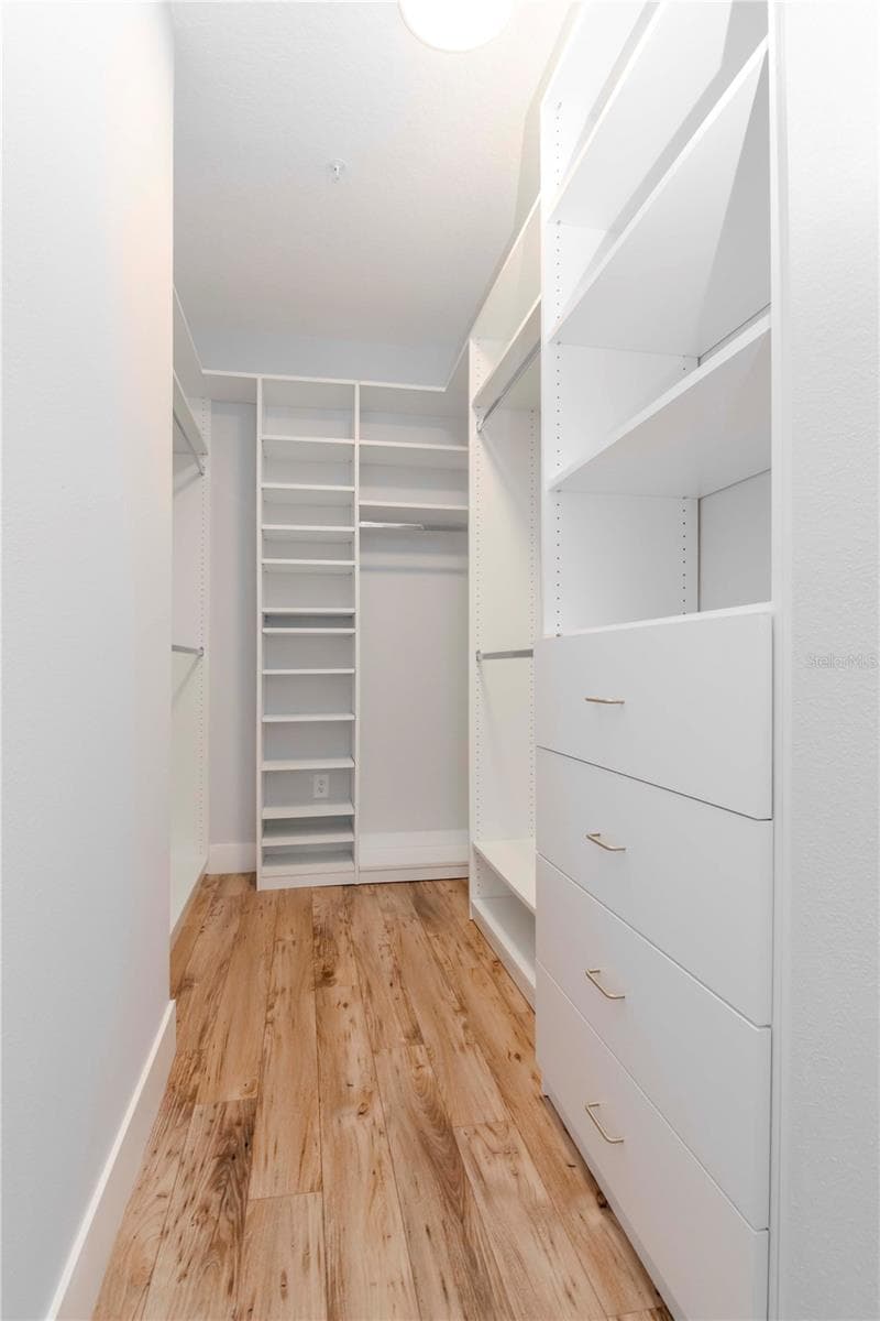 Primary Bedroom Custom Walk-In Closet by Closets By Design - 800 S DAKOTA AVE #207, TAMPA