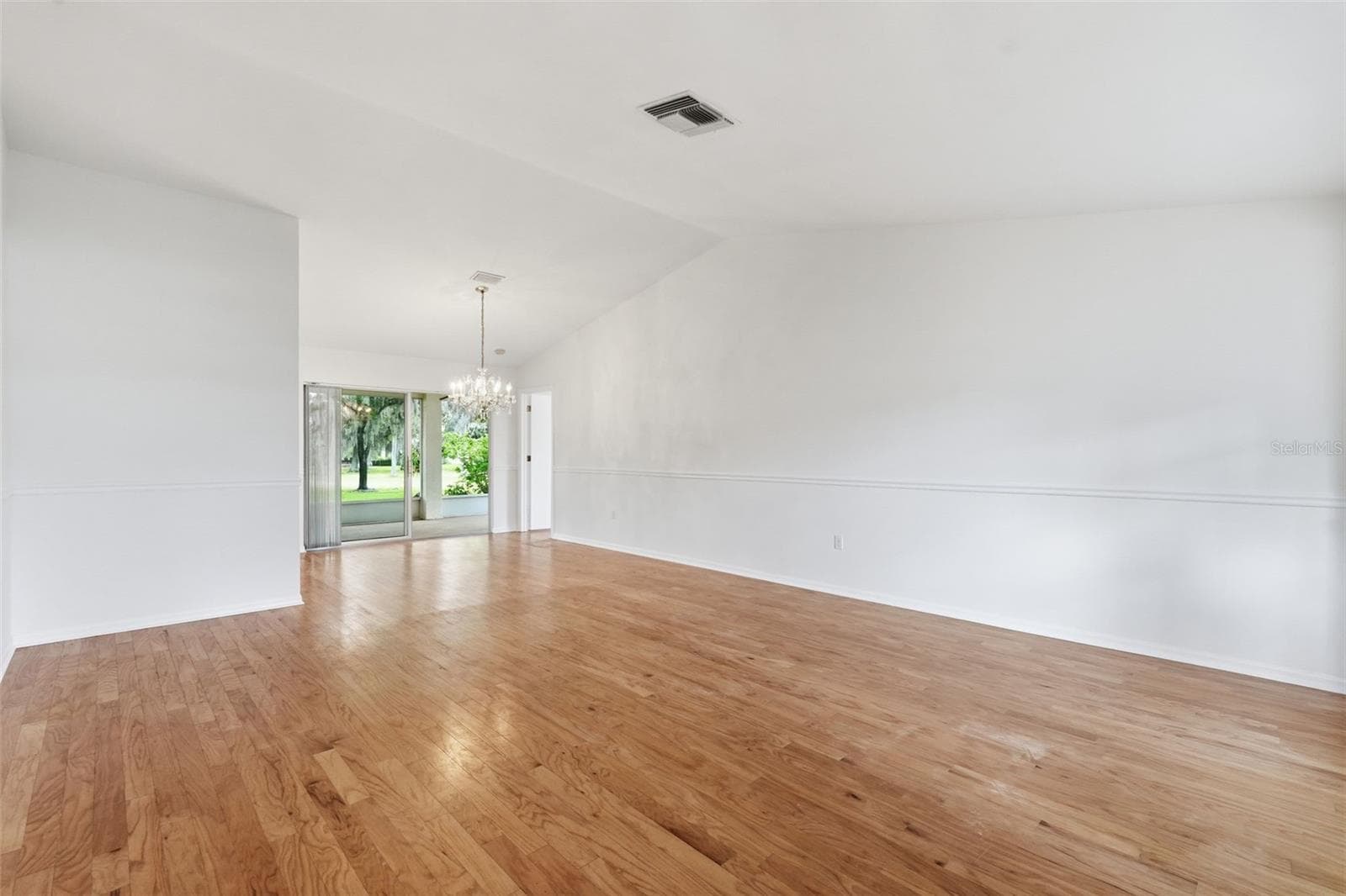 From front door entrance - Spacious living room. Chandelier does NOT convey. - 1444 CANBERLEY CT, NEW PORT RICHEY