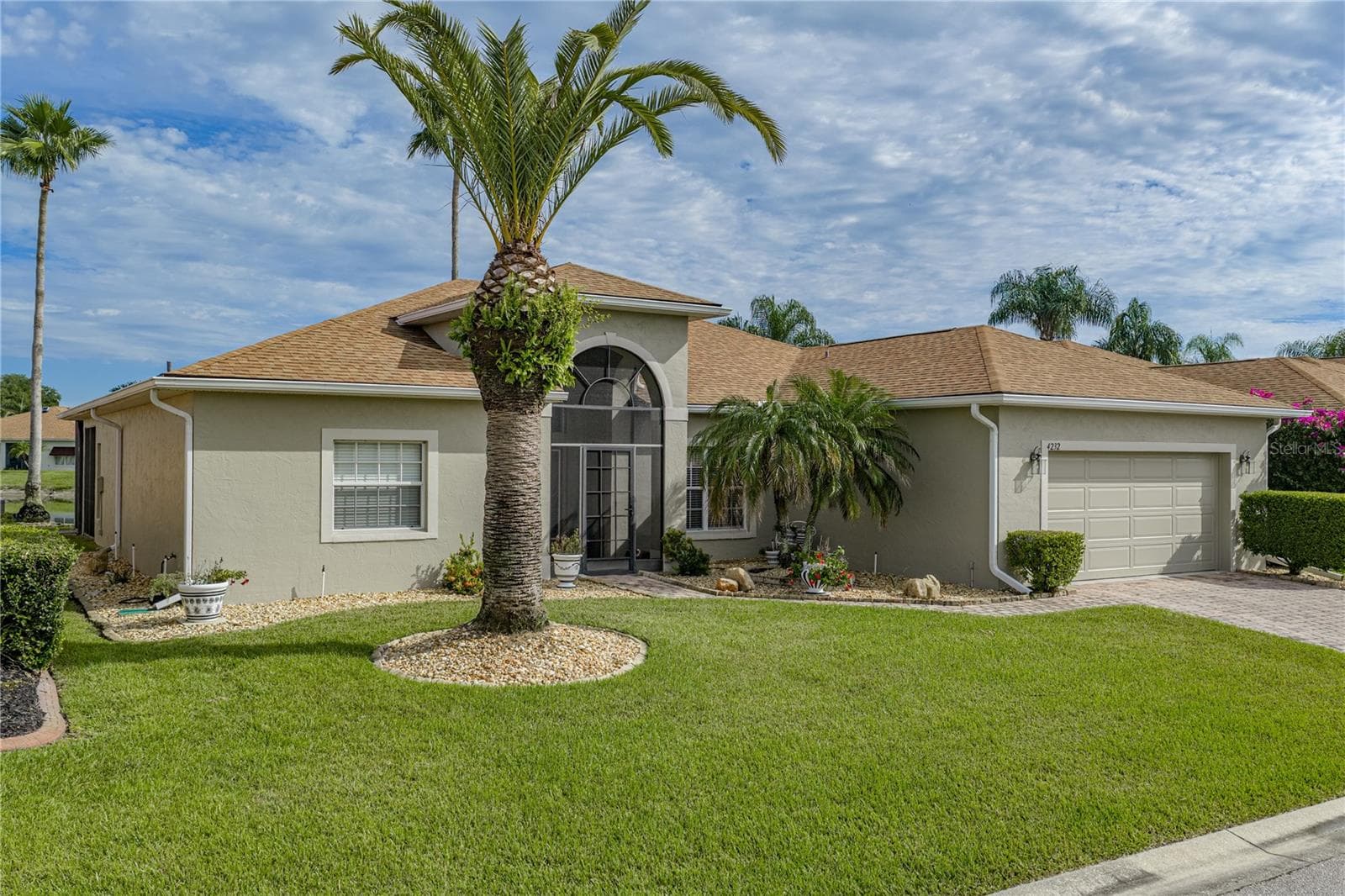 The quality landscaping encircles this home and includes stately palms and other plantings. - 4232 DORNOCH DR, LAKE WALES
