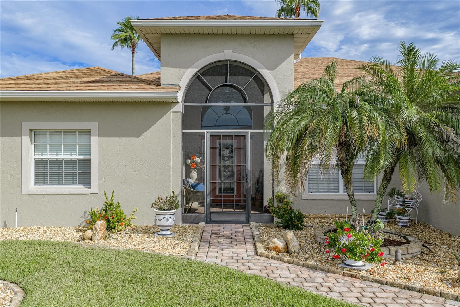 The screened covered front entry adds another place to enjoy the famous Florida climate. The screening adds a level of security while making cross ventilation a "breeze". - 4232 DORNOCH DR, LAKE WALES