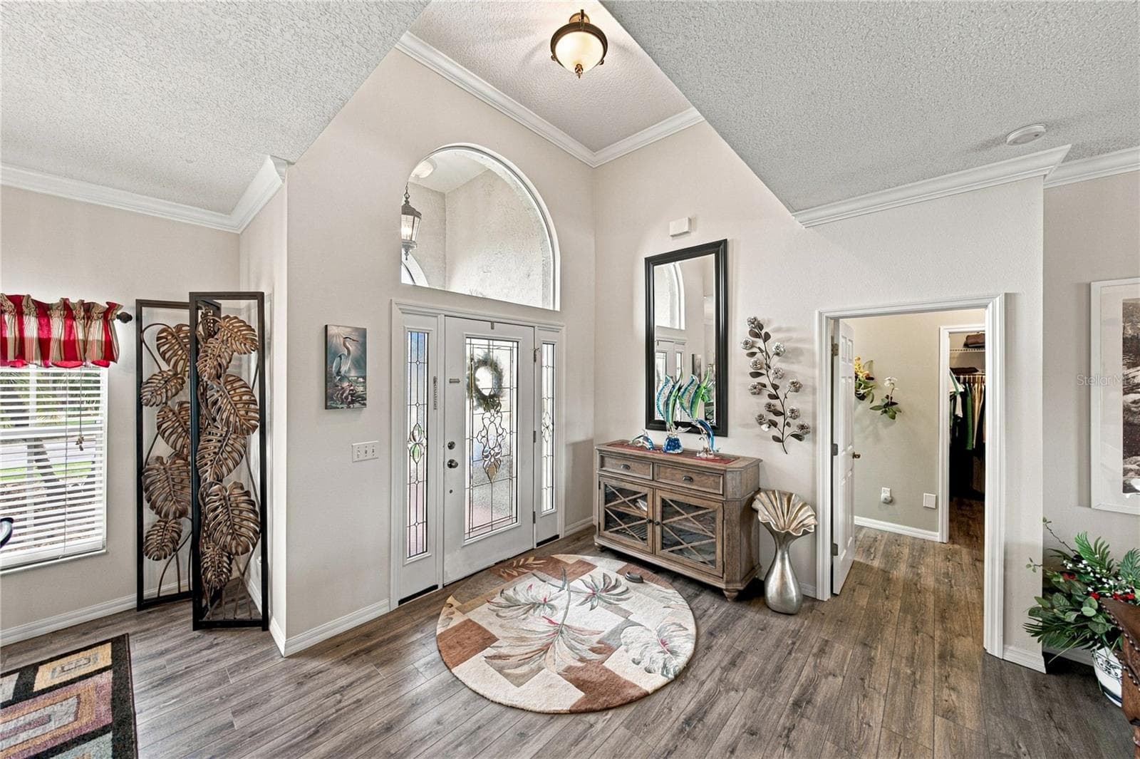 This split floor plan home has the primary suite filling the entire west wing of this home. The doorway is visible on the right. - 4232 DORNOCH DR, LAKE WALES