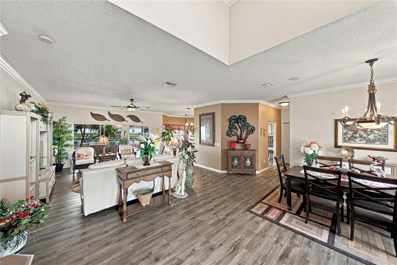 This view from the foyer shows the efficiency of the home's layout from the foyer to the dining room to the living room to the kitchen and dinette. - 4232 DORNOCH DR, LAKE WALES