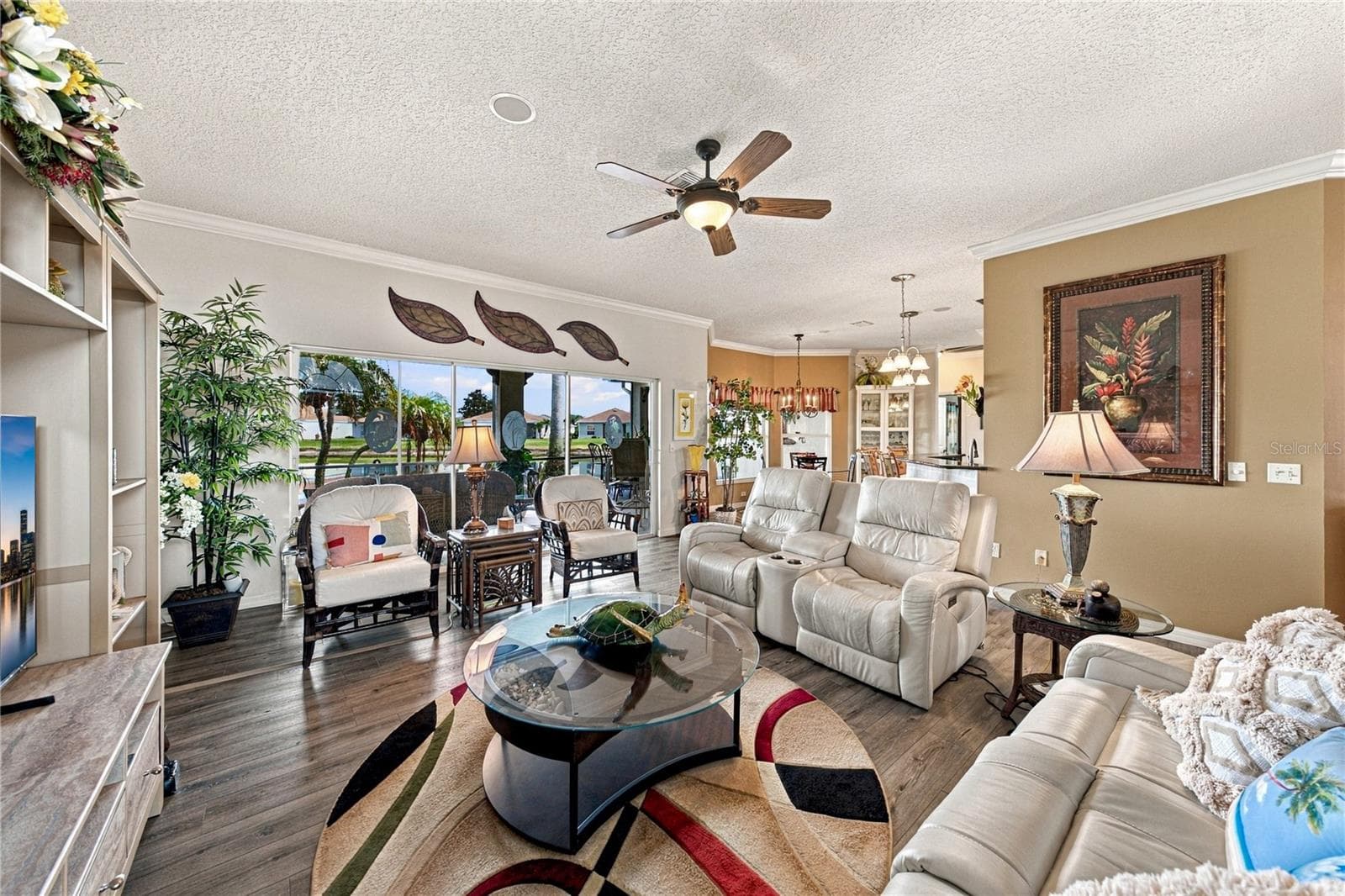 The triple slider at the north end of the living room opens to the expanded covered and "bird caged" lanai. - 4232 DORNOCH DR, LAKE WALES