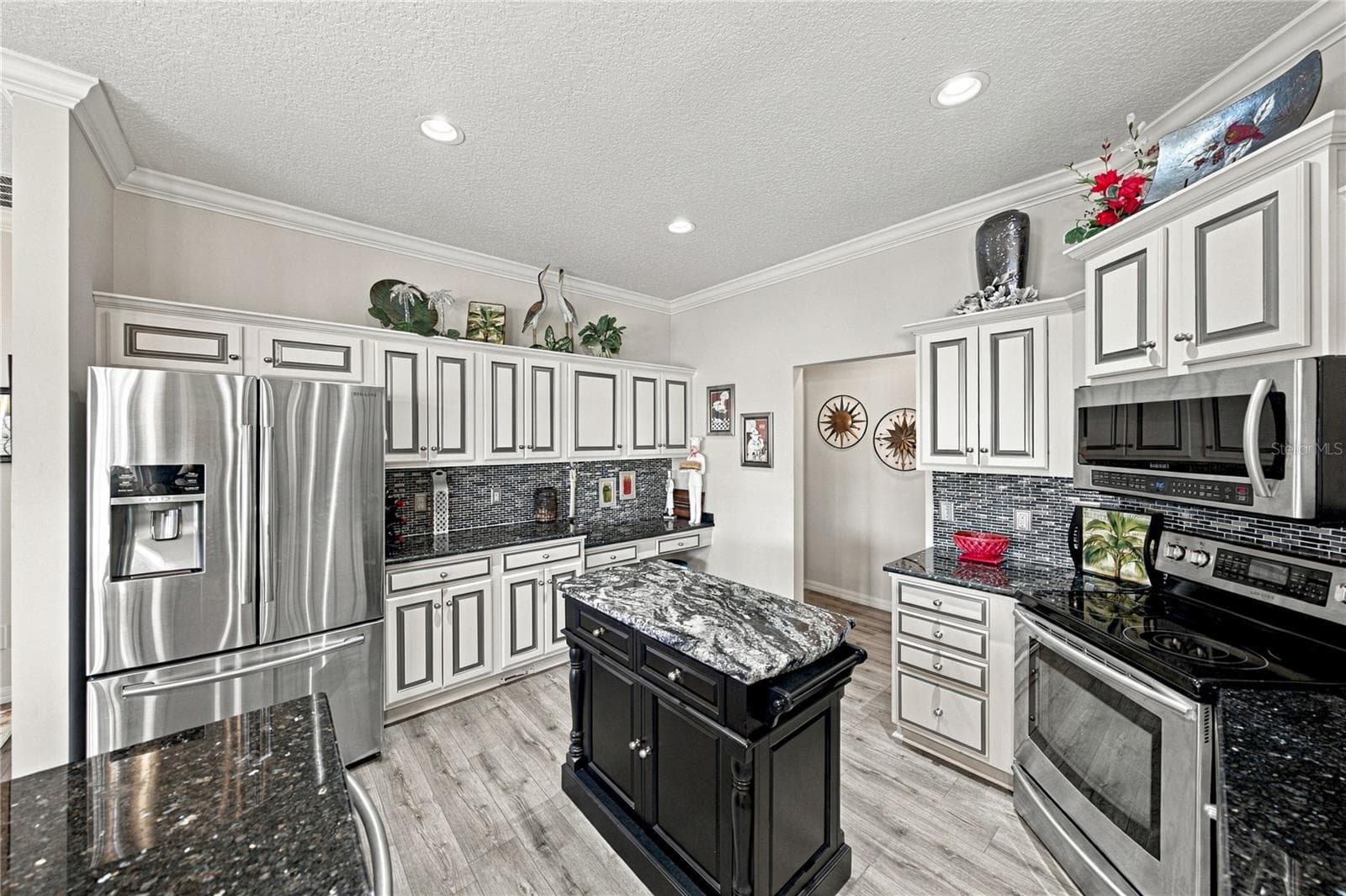 The newer stainless-steel appliances and prep island are pluses! - 4232 DORNOCH DR, LAKE WALES
