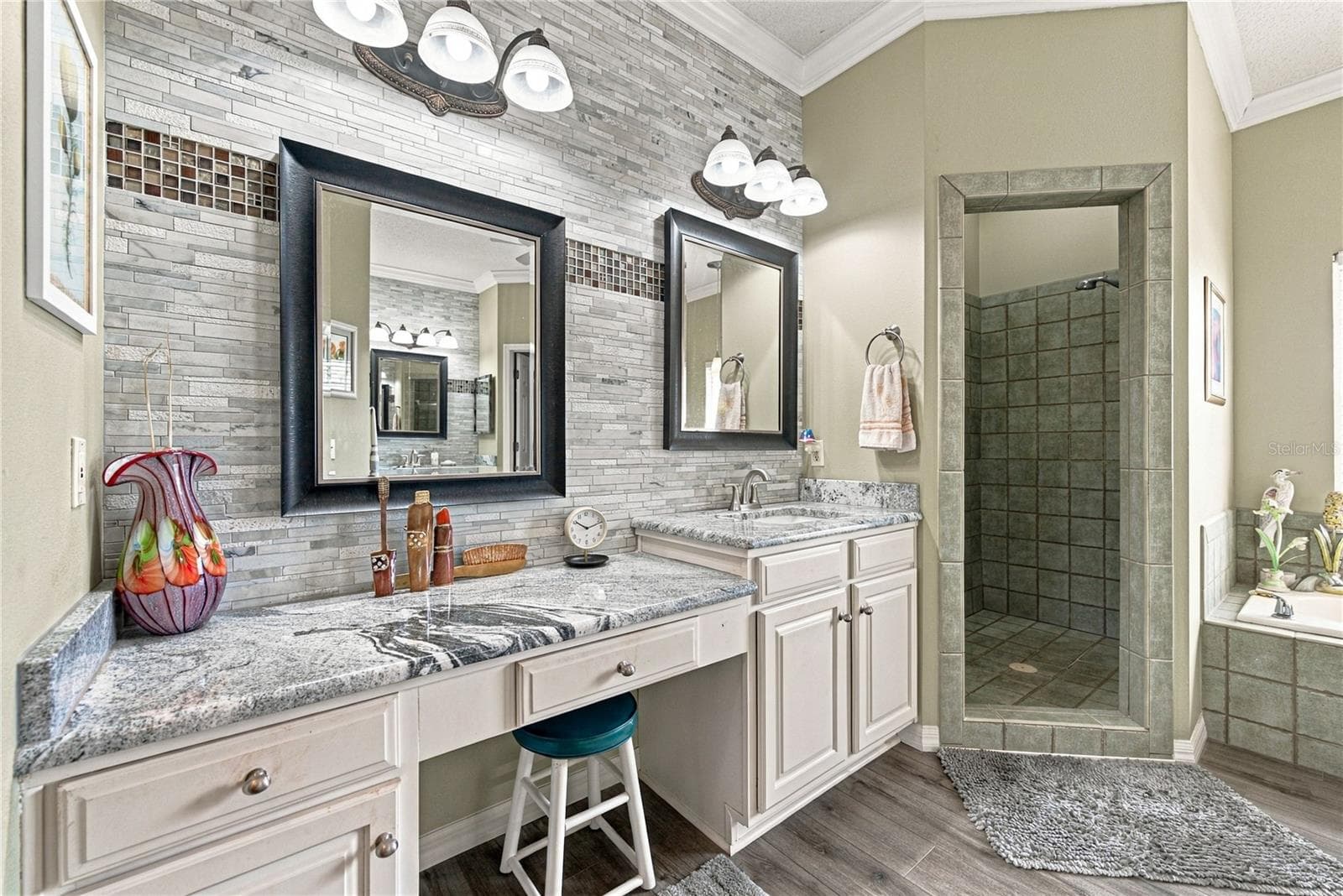 The primary bath has been recently remodeled and features separate vanities. - 4232 DORNOCH DR, LAKE WALES