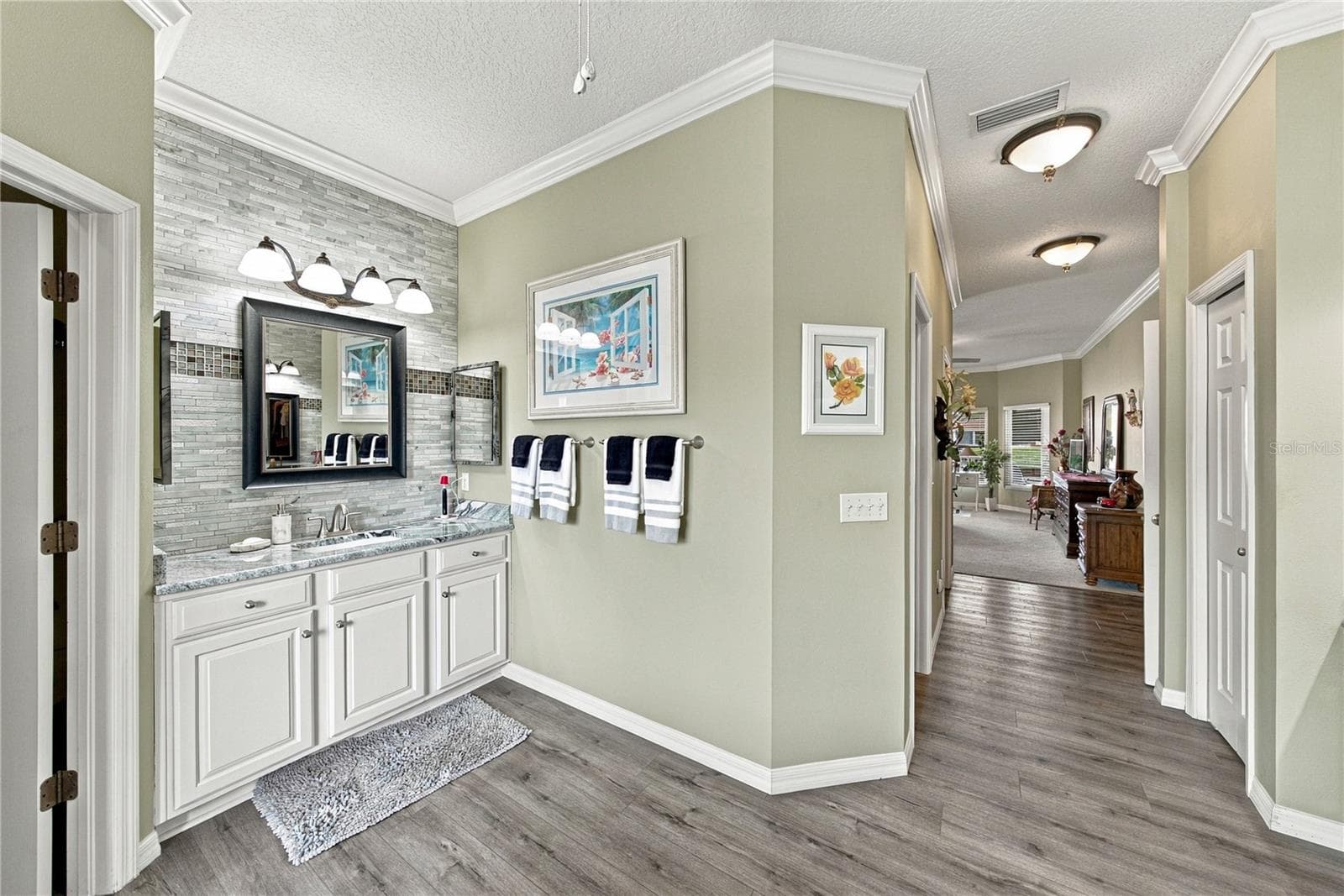 The west vanity also has stone countertops, stone wall with accents, and upgraded fixtures. - 4232 DORNOCH DR, LAKE WALES