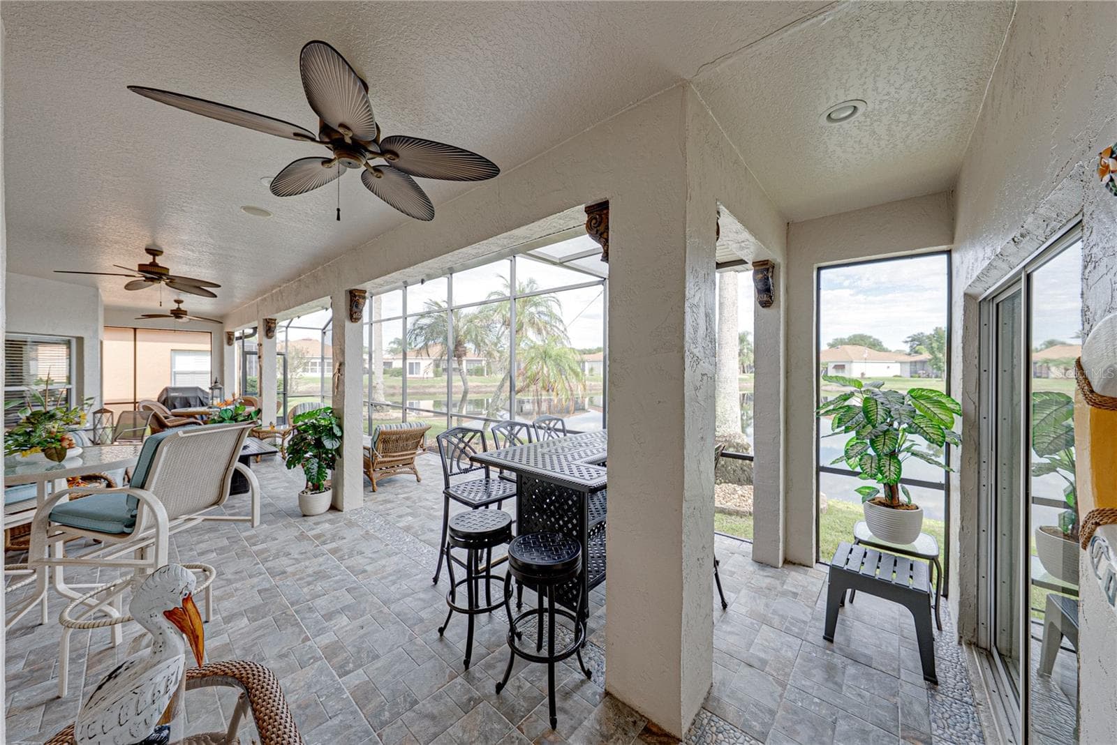 The expanded covered and bird caged lanai has ceramic tile flooring and 2 ceiling fans. - 4232 DORNOCH DR, LAKE WALES