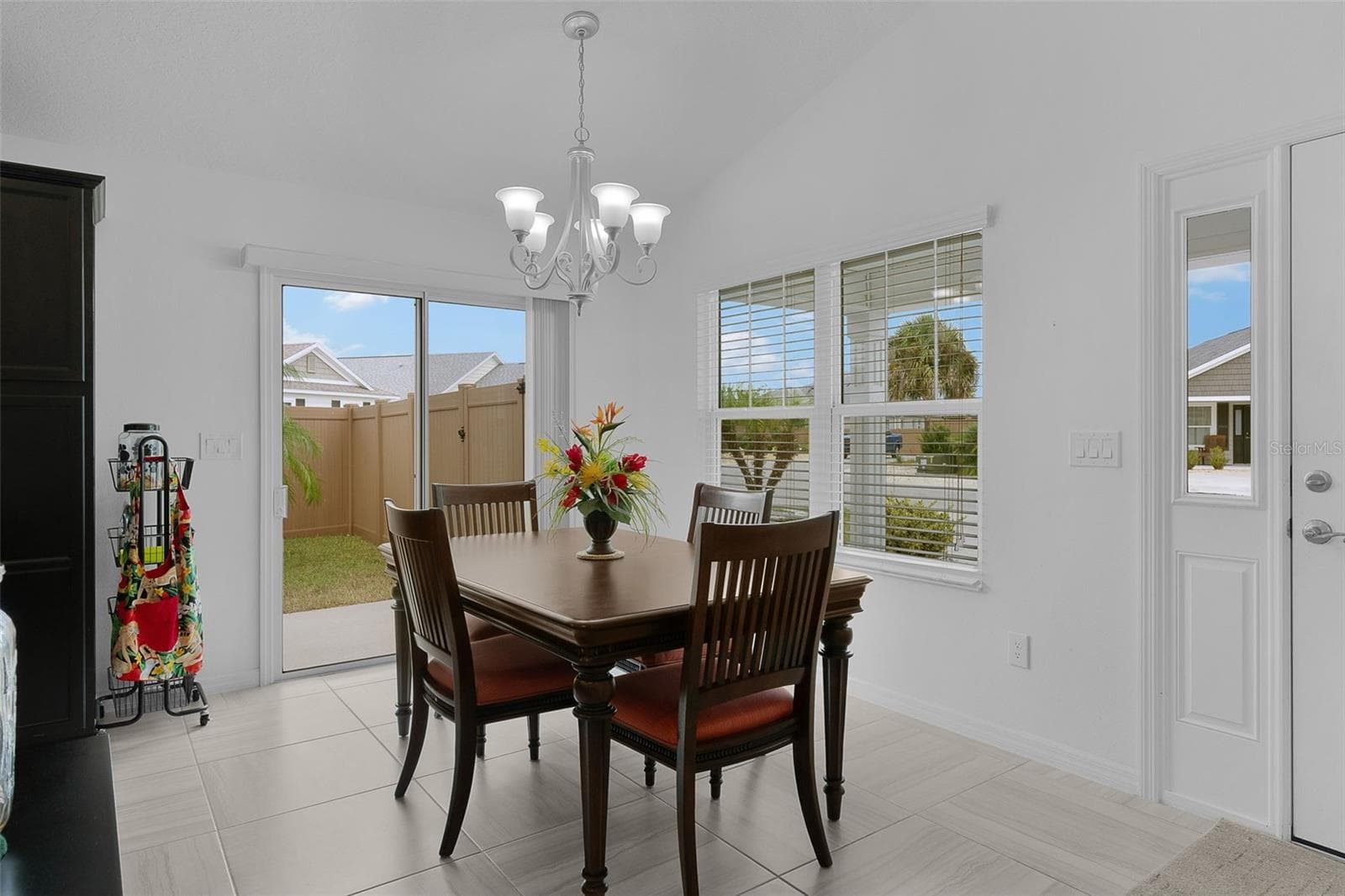 The dining room has a slider to the side patio -- perfect for grilling! - 3144 ROBBS RD, THE VILLAGES