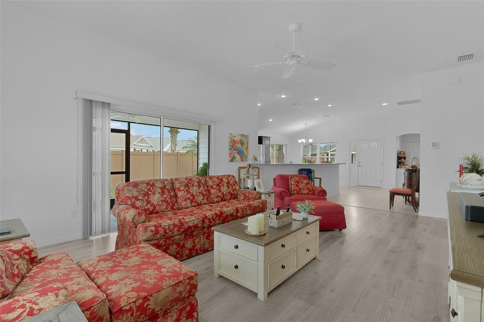 Large living room with the side screen lanai to extend living space outdoors - 3144 ROBBS RD, THE VILLAGES