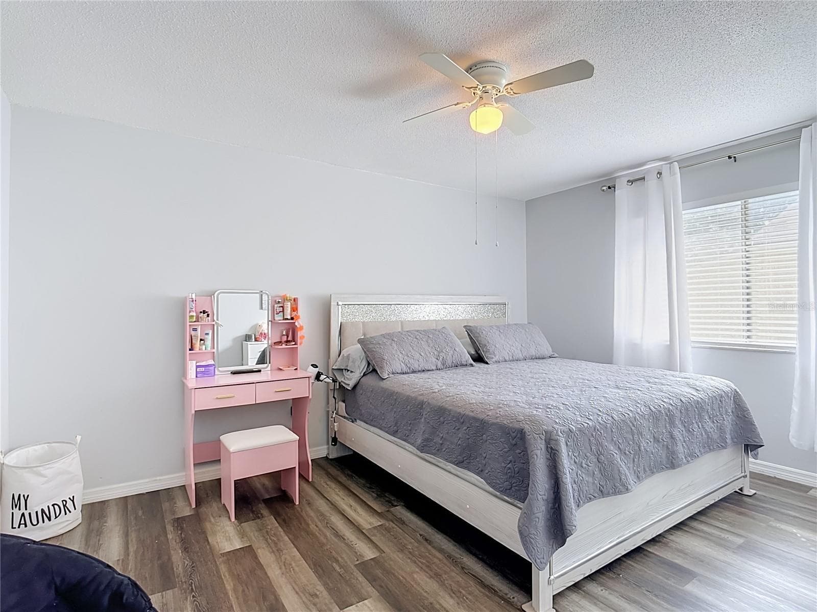 Second bedroom with wood-look flooring. - 1106 SPRING MEADOW DR, KISSIMMEE