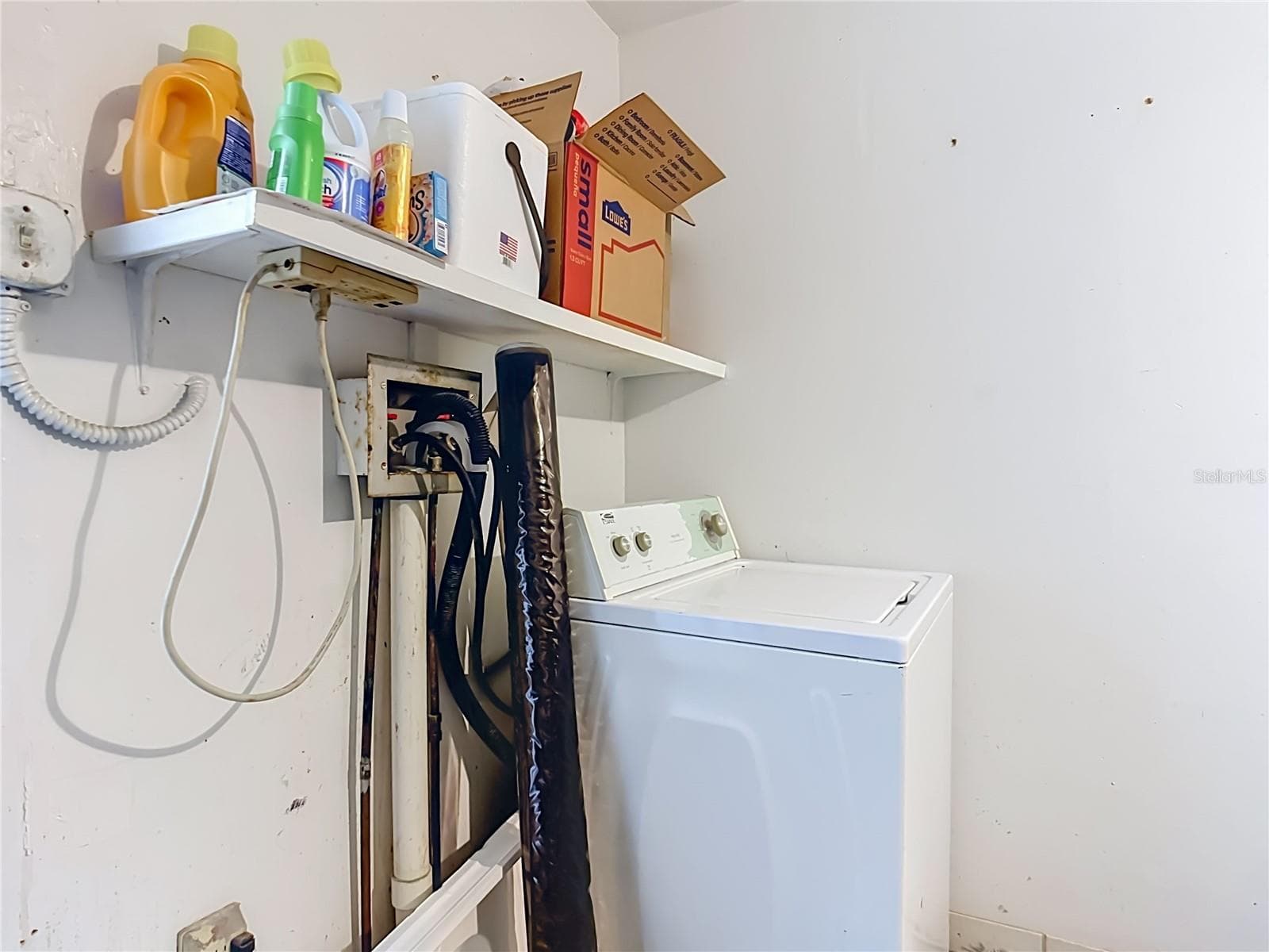 Laundry area with overhead storage. - 1106 SPRING MEADOW DR, KISSIMMEE