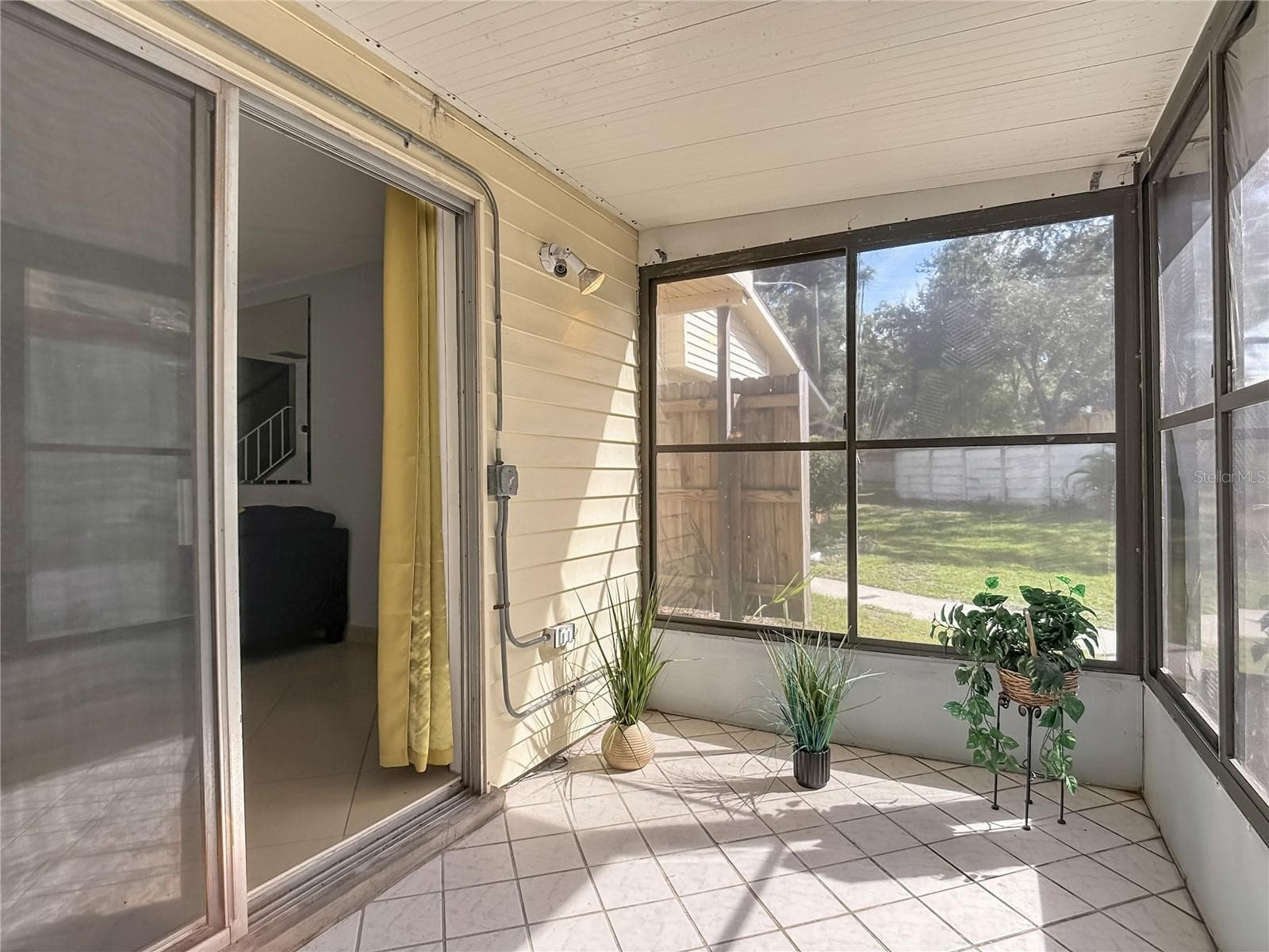 Screened porch with sliding-door access. - 1106 SPRING MEADOW DR, KISSIMMEE