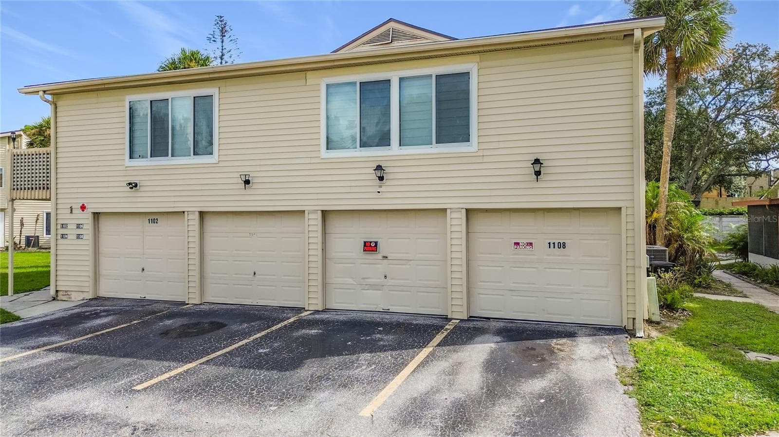 Exterior view with garage entrances. - 1106 SPRING MEADOW DR, KISSIMMEE