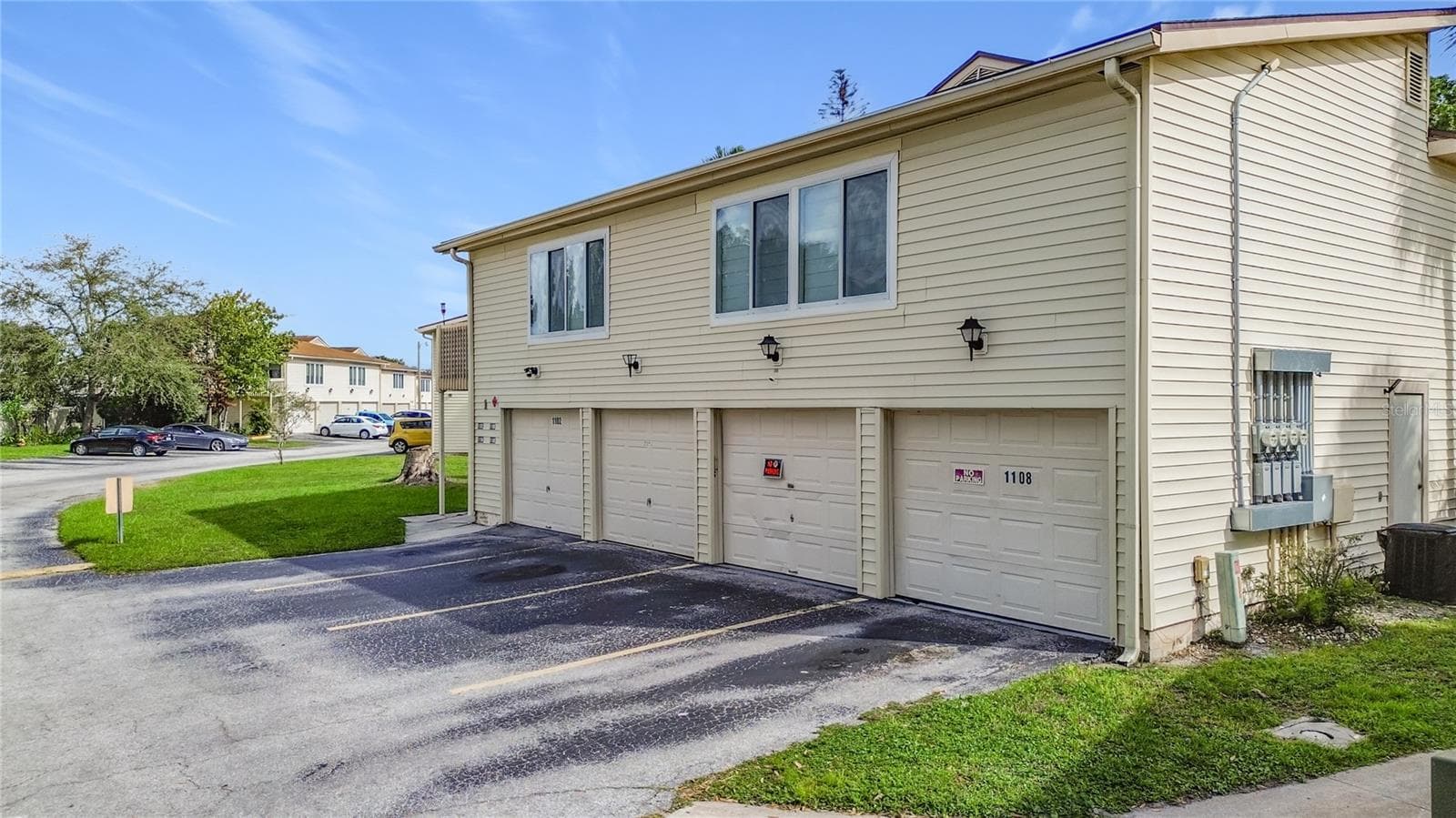 Garage entrances and parking area. - 1106 SPRING MEADOW DR, KISSIMMEE