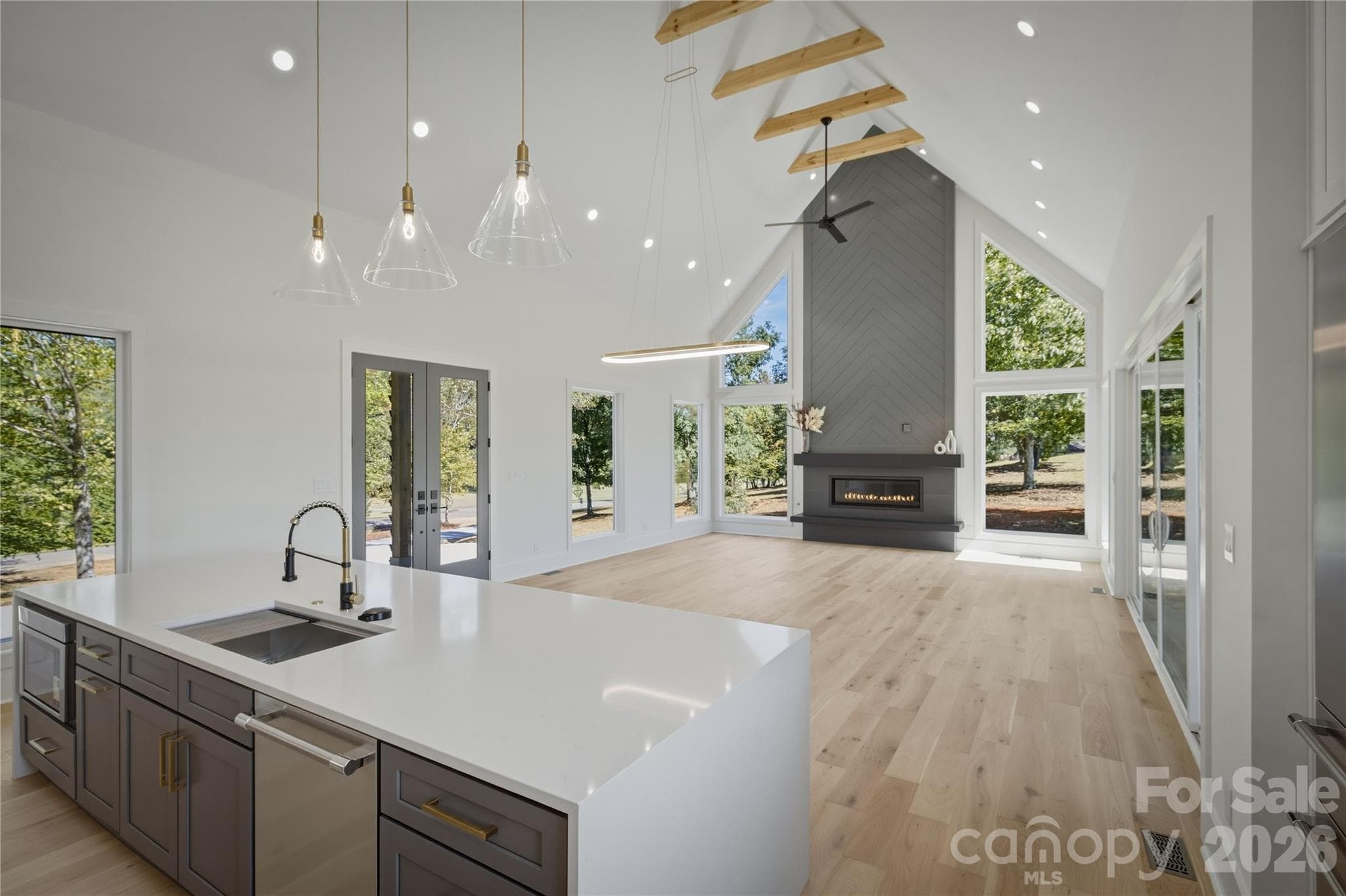 Upon entry from the front door, you immediately notice the open feel of the home, the vast views that the large windows offer, and the premium materials throughout this home. - 2303 Paddock Circle, Morganton