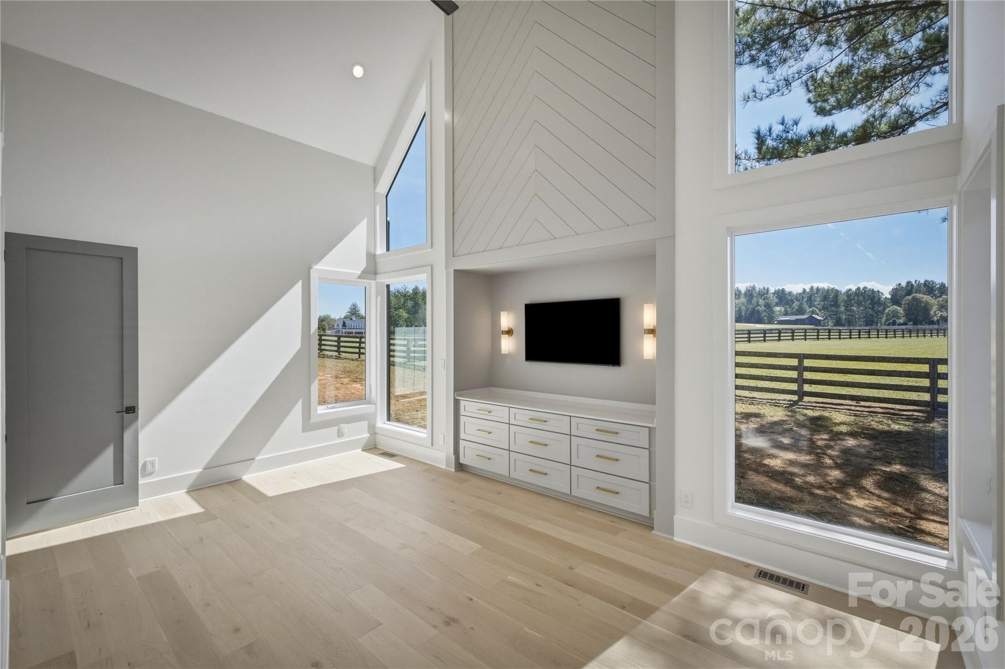 The vistas out the wall of windows is quite breathtaking, and the really tall ceilings in this room are exquisite! - 2303 Paddock Circle, Morganton