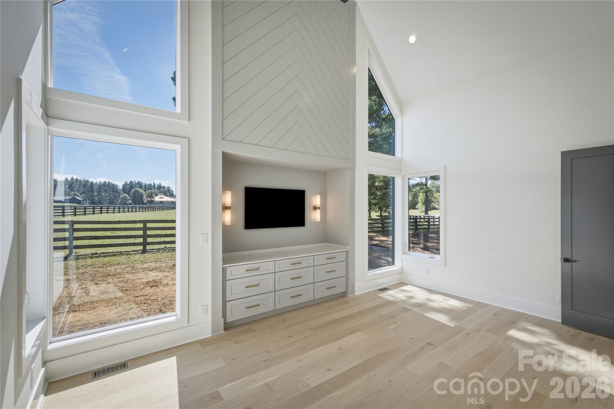 Here is the owners' retreat. Notice the built-in cabinetry and an awesome niche to hang the TV all inset in a beautiful feature wall. What a unique element! - 2303 Paddock Circle, Morganton