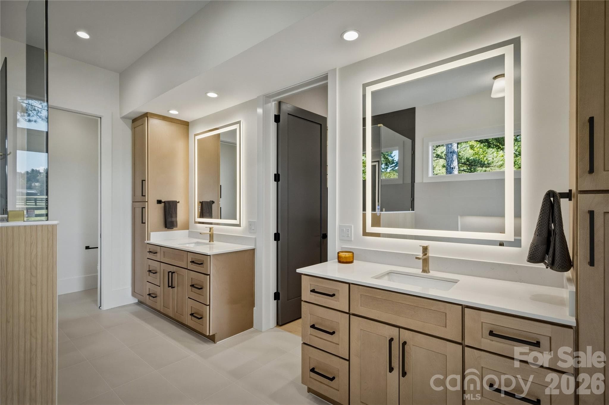 There are dual vanities and sinks and lighted mirrors. - 2303 Paddock Circle, Morganton