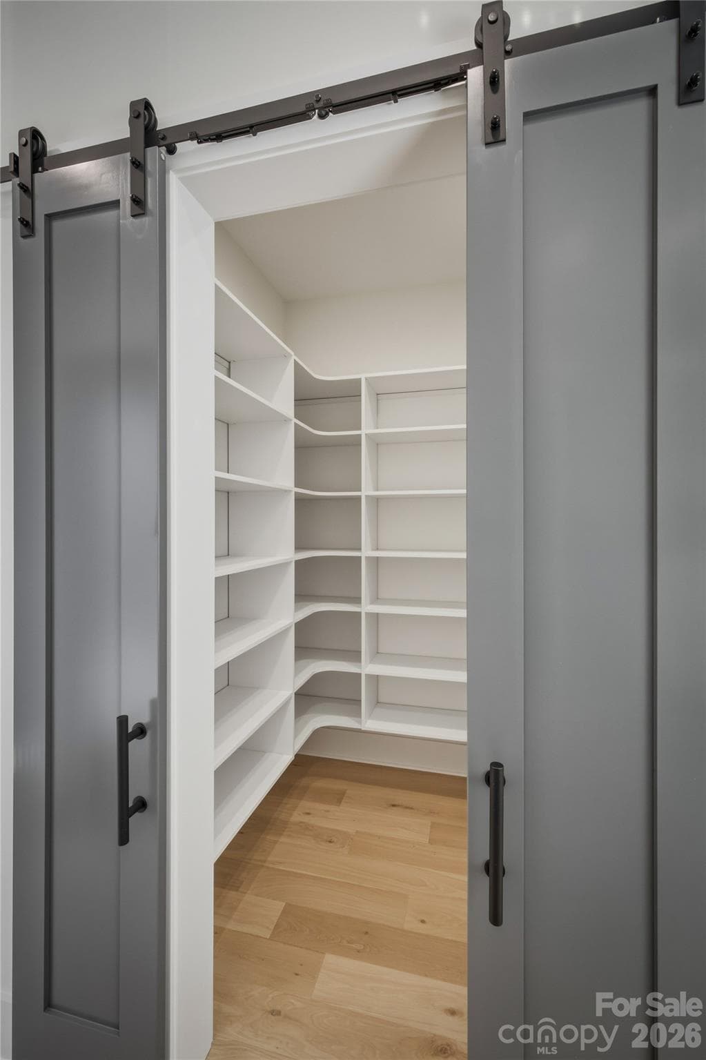 Behind these elegant barn doors, you will discover a walk-in pantry to keep all of your dry goods and kitchen supplies neatly stored away. - 2303 Paddock Circle, Morganton