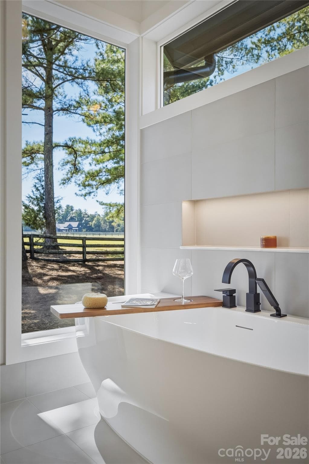 The freestanding tub is luxurious with its wide lighted niche, transom window, and the views! This is the perfect place to relax and unwind! - 2303 Paddock Circle, Morganton