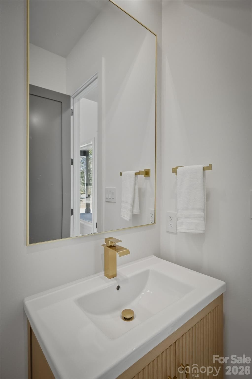 Here is another view of the powder room which is located just around the corner from the kitchen. - 2303 Paddock Circle, Morganton