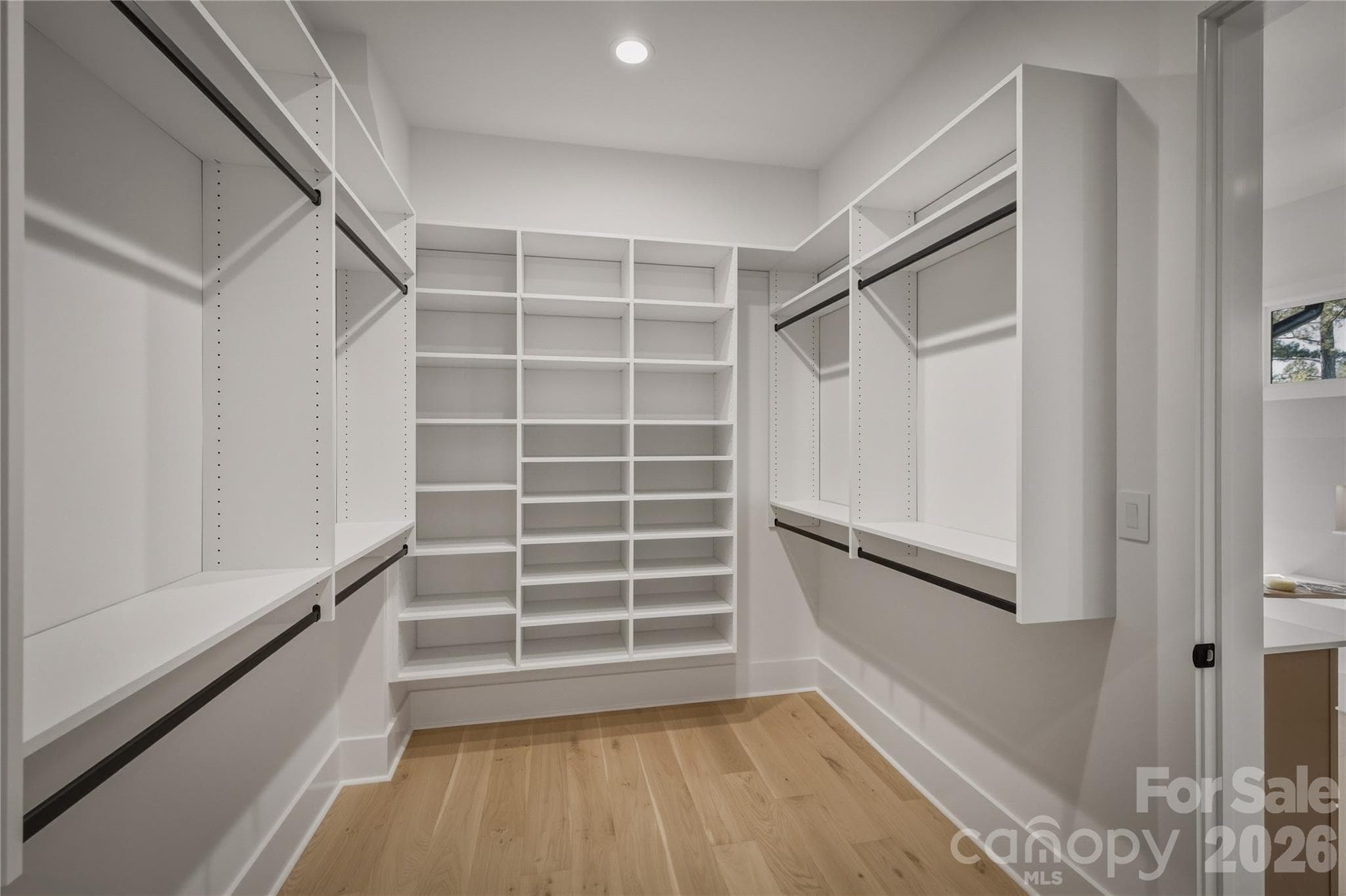 The last part of the owners' retreat is this spacious closet. This custom shelving system as well as the other bedroom closet systems are from Carolina Closets. - 2303 Paddock Circle, Morganton