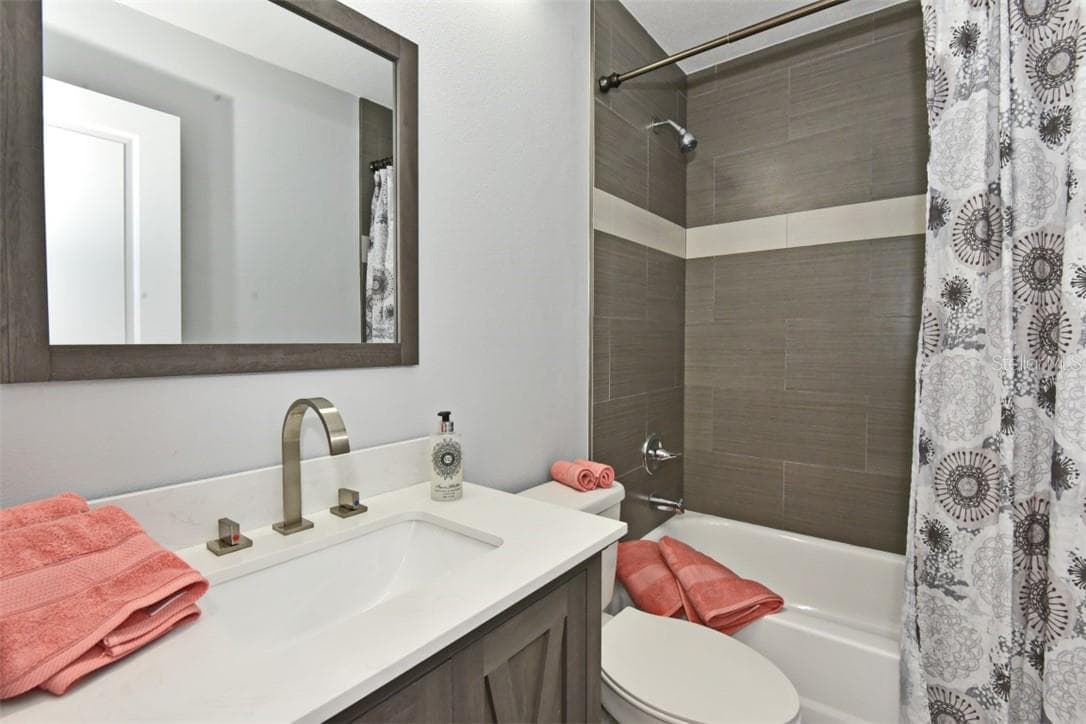 Raised ceiling above the tub/shower combo with all new tile, toilet and vanity with elegant POLISHED DETAILS, EVERYDAY STYLE, brushed nickel hardware - 139 OLIVE TREE CIR, ALTAMONTE SPRINGS