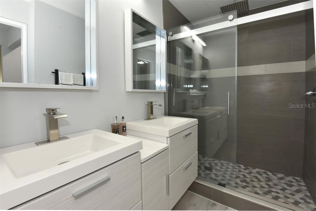 Completely re-build master bathroom with floating double sinks, stylish faucets, frameless sliding shower door, large walk-in shower with rain shower head. You have to come and see this luxurious master ensuite. - 139 OLIVE TREE CIR, ALTAMONTE SPRINGS