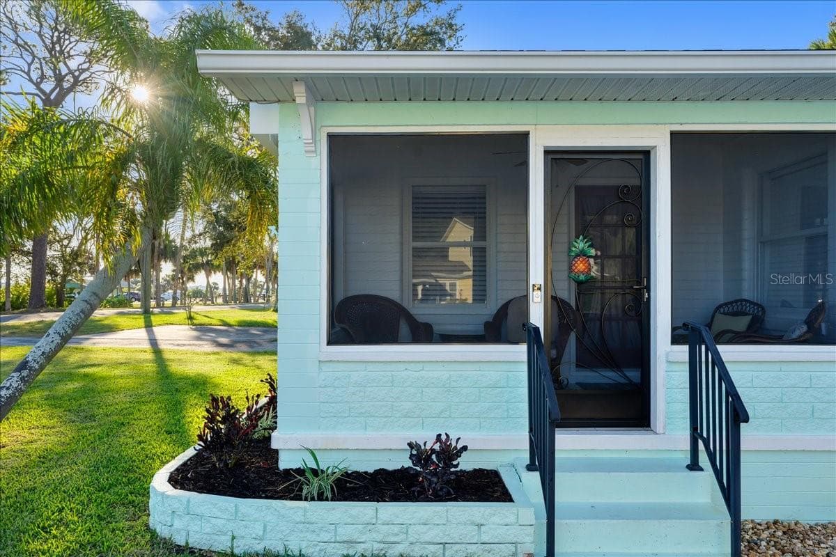 Screened front porch looks out to Halifax River - 1146 RIVERSIDE DR, DAYTONA BEACH
