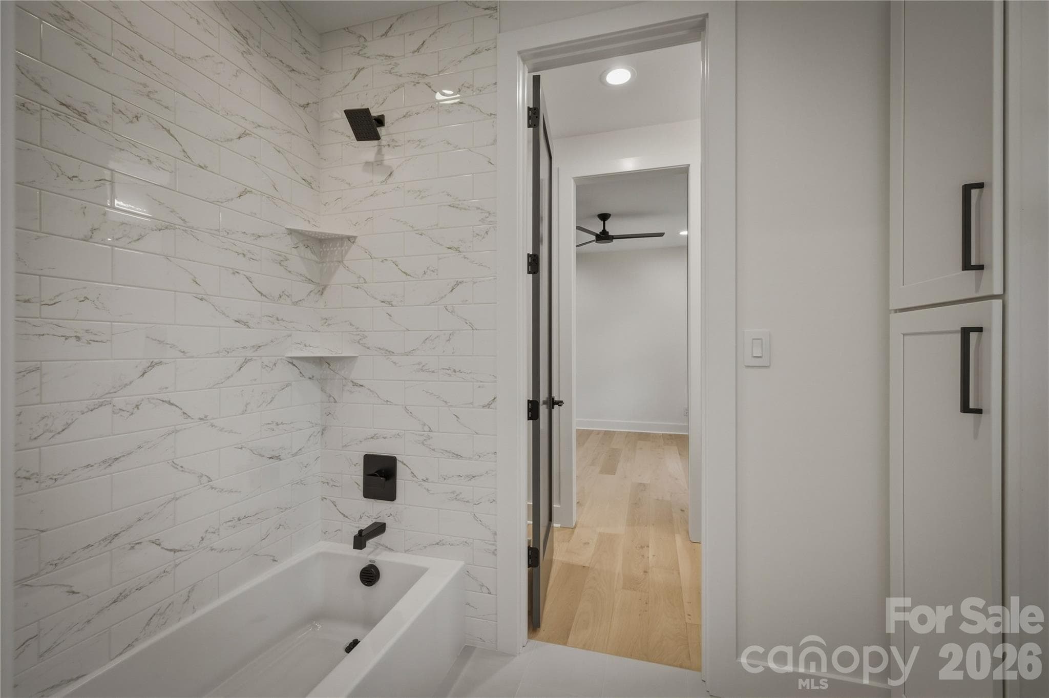 The shared tub/shower and  for Suites #2 and #3 and water closet area is next. - 2303 Paddock Circle, Morganton