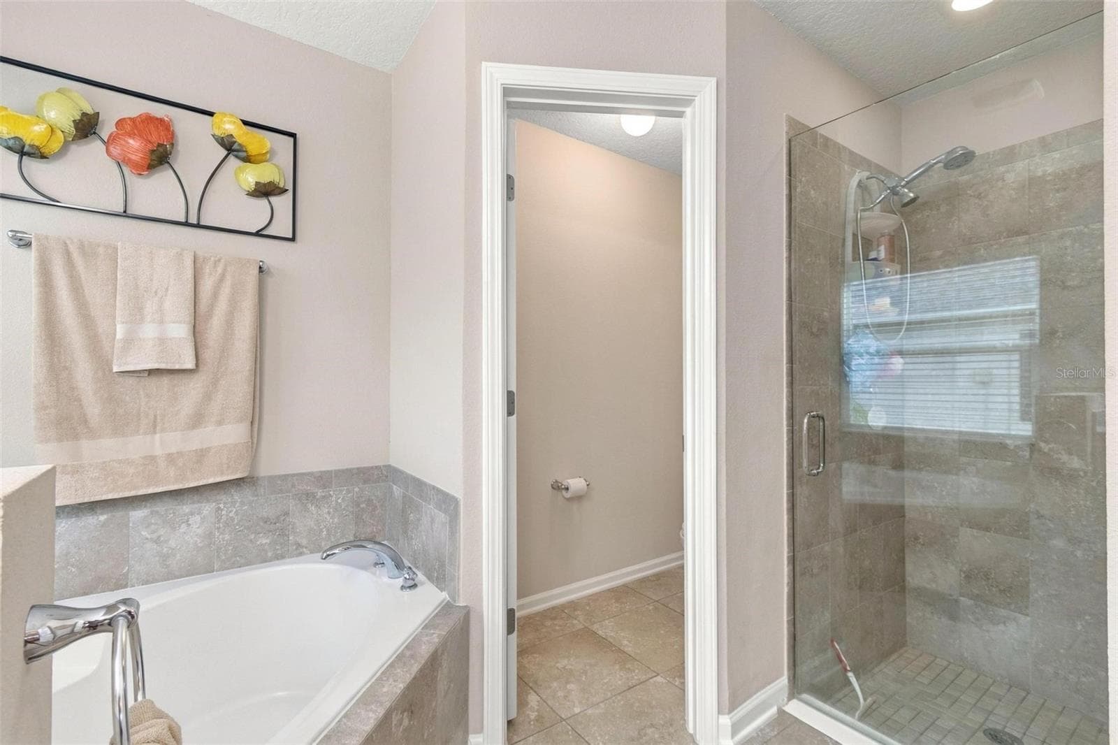 Tub, separate shower and WC in primary ensuite bath 1 - 8 COUNTRY CLUB HARBOR CIR, PALM COAST